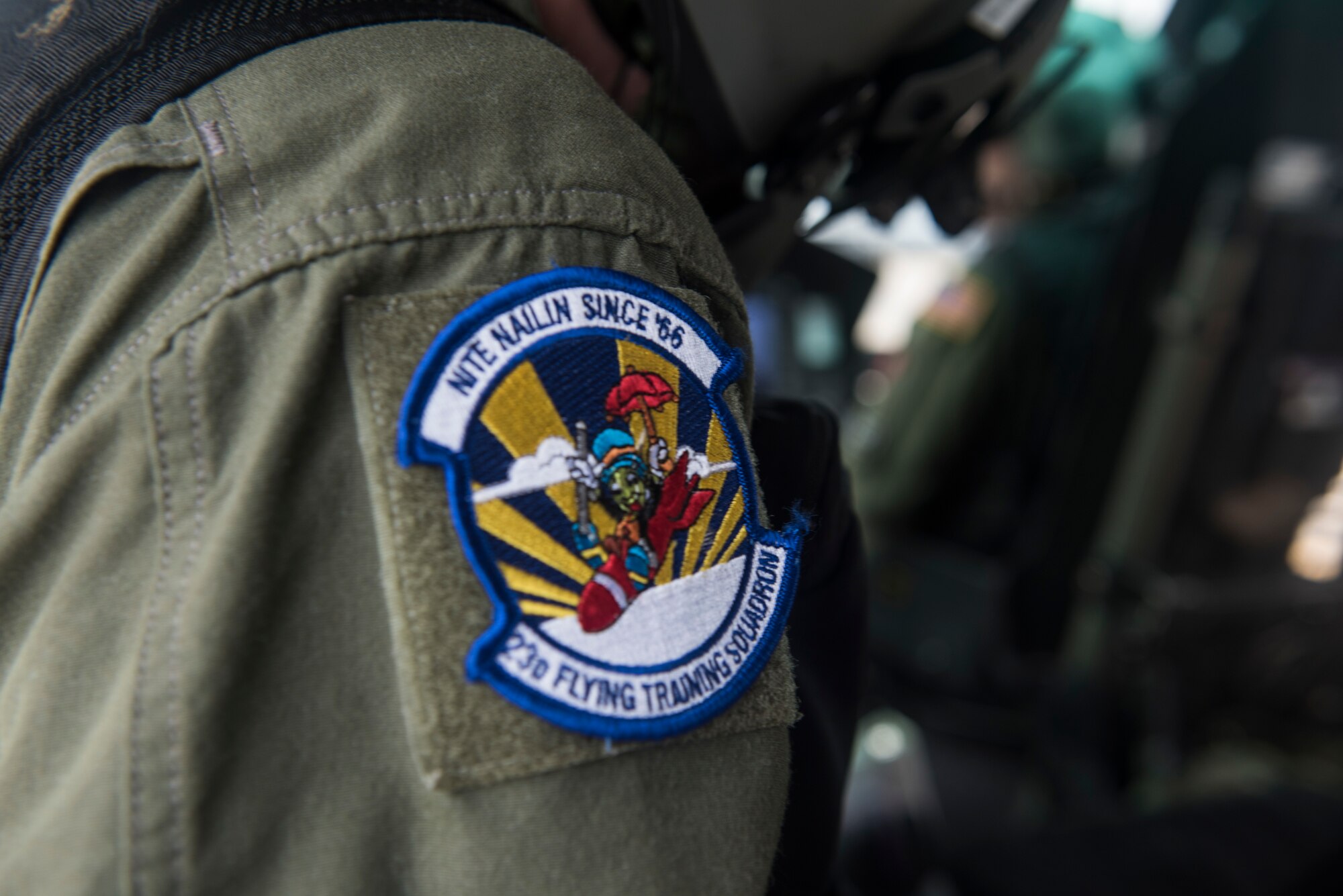 A 23rd Flying Training Squadron patch is attached to the shoulder of a TH-1H helicopter crew member as he prepares for takeoff during Pathways to Blue April 6, 2018, on Keesler Air Force Base, Mississippi. Throughout the two-day event, ROTC cadets and enlisted personnel traveled through this diverse and inclusive event to better aim themselves to become future Air Force leaders. The event provided more than 280 cadets from 15 different colleges and universities a chance to receive hands-on demonstrations of various career fields. (U.S. Air Force photo by Senior Airman Travis Beihl)