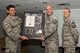 U.S. Air Force Reserve Master Sgt. Dennis Kash, first sergeant, 913th Maintenance Squadron, is presented with a framed memento from Col. Christopher Lay, the 913th Airlift Group commander, and Chief Master Sgt. Kimberly Lord, superintendent, 913th AG, during an All Call, April 7, 2018, at Little Rock Air Force Base, Ark. Kash was presented the memento for his selection as one of the Twenty-Second Air Force Outstanding Airmen of the Year in the first sergeant category. (U.S. Air Force photo by Master Sgt. Jeff Walston)