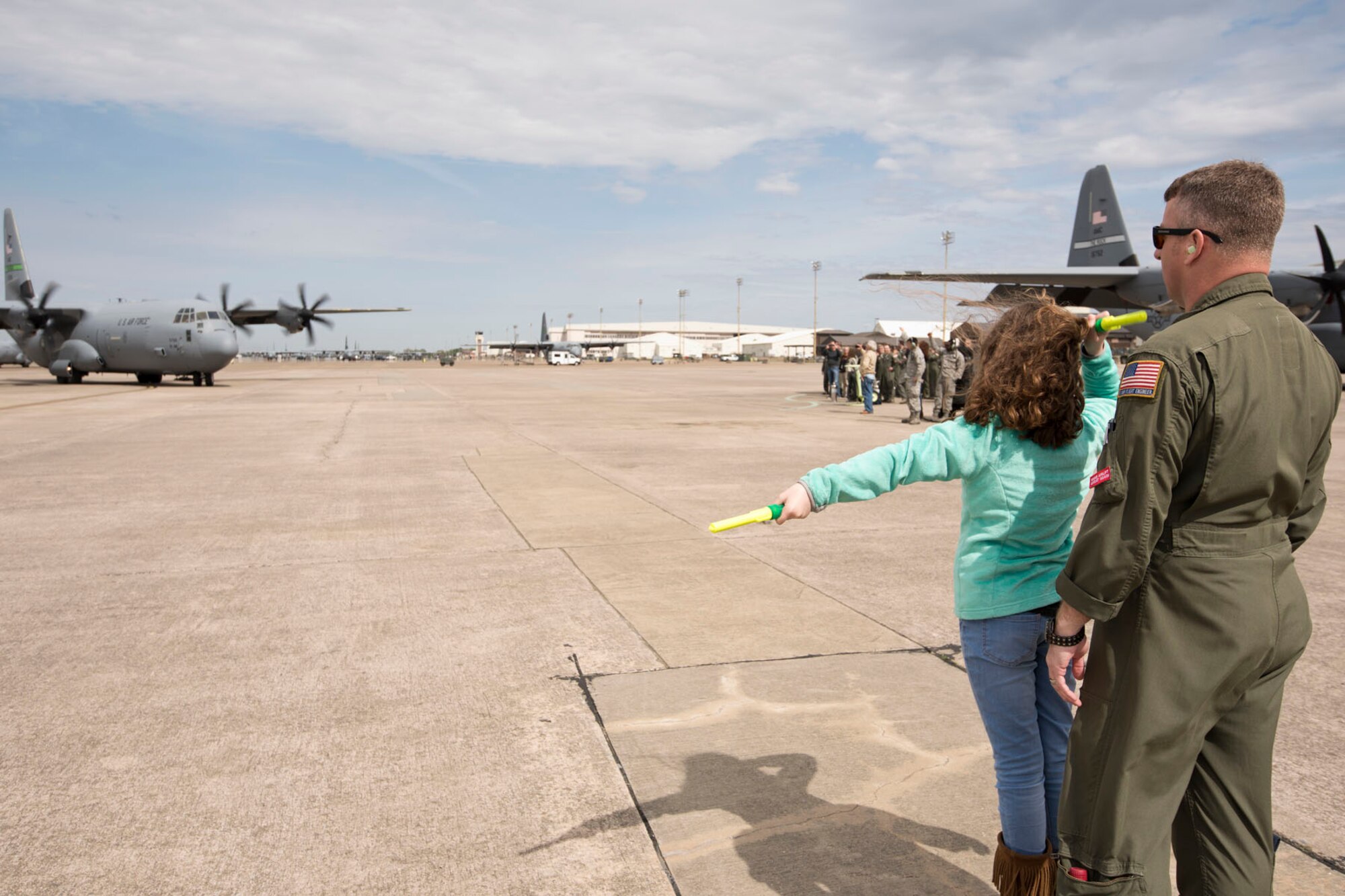 Anna Claire Smith, daughter of Maj. Claude Smith, marshalls a C-130J Super Hercules piloted by her father April 5, 2018, at Little Rock Air Force Base, Ark. Smith was completing his last sortie in a C-130J before retiring from the Air Force Reserve after 28 years of faithful military service. (U.S. Air Force photo by Master Sgt. Jeff Walston)