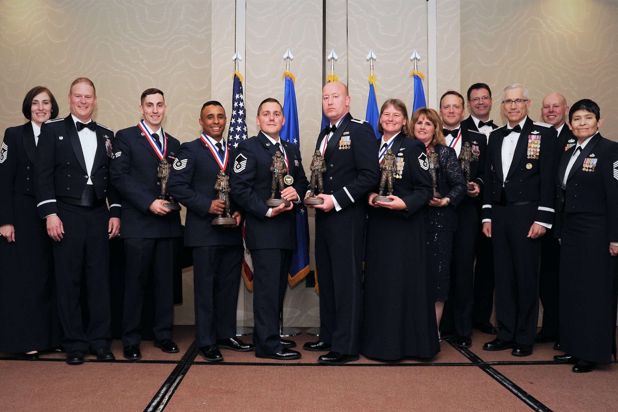 The 302nd Airlift Wing 2017 annual award winners pose for a photo during a ceremony in Colorado Springs, Colorado, April 7, 2018. The annual awards program recognizes outstanding achievements in the areas of leadership, job performance, significant self-improvement and contributions to both on and off-base communities. (U.S. Air Force photo by Staff Sgt. Frank Casciotta)