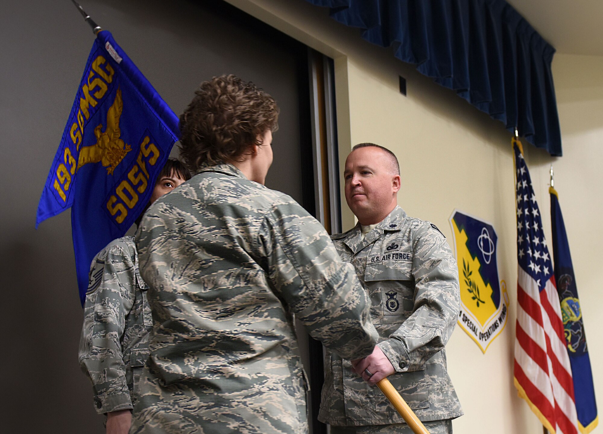 U.S. Air Force Lt. Col. Barry Strube, 193rd Special Operations Security Forces Squadron commander, Pennsylvania Air National Guard, accepts the guidon from Col. Susan Garrett, 193rd Special Operations Mission Support Group commander, during an assumption of command ceremony April 8, 2018, in Middletown, Pennsylvania. The ceremony began with preliminary honors and ended with the symbolic passing of the guidon. (U.S. Air National Guard photo by Senior Airman Julia Sorber/Released)