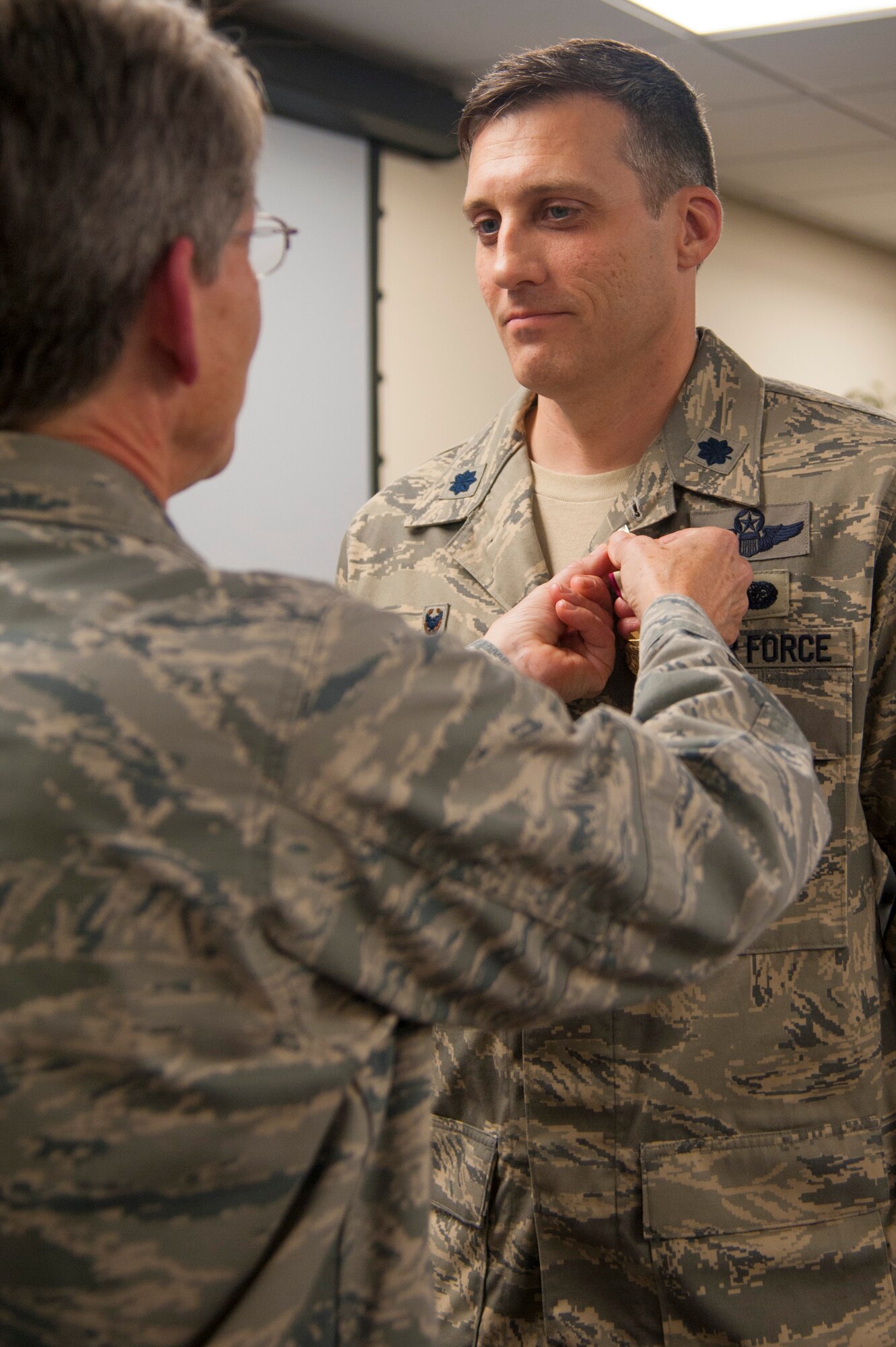 Col. Caroline Evernham pens on the Meritorious Service Medal on Lt. Col. Michael Stapleton. The award was given during the change of the command ceremony held during the Unit Training Assembly.