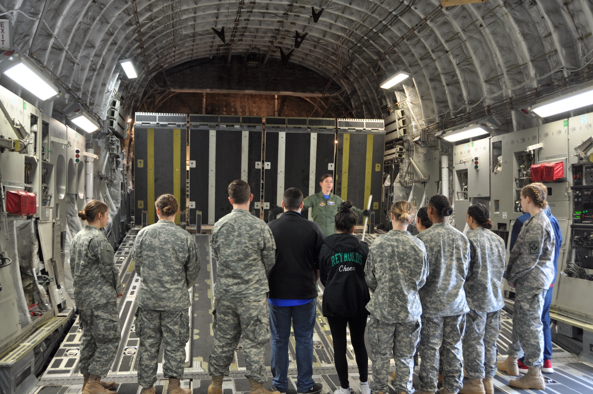 U.S. Air Force Tech. Sgt. Heather Normand, assigned to the 728th Airlift Squadron tells Reynolds High School Army JROTC cadets the job responsibilities of a C-17 loadmaster at Joint Base Lewis-McChord on April 7, 2018. (U.S. Air Force by 1st Lt. Alyssa Hudyma)