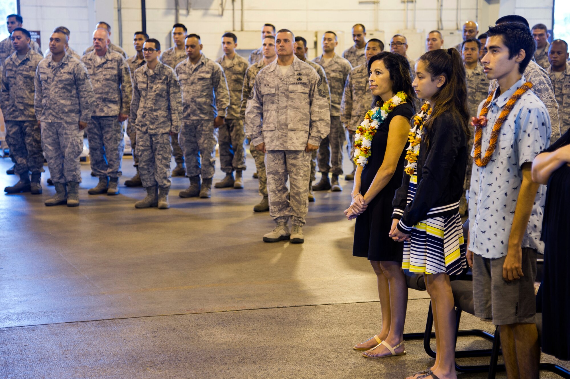 The family of U.S. Air Force Maj. Kenneth Ruggles Jr., which include his wife, Michelle Ruggles, and children, Kadyn and Davenon, attend his assumption of command for the 48th Aerial Port Squadron during a ceremony at Joint Base Pearl Harbor-Hickam, Hawaii, April 7, 2018.