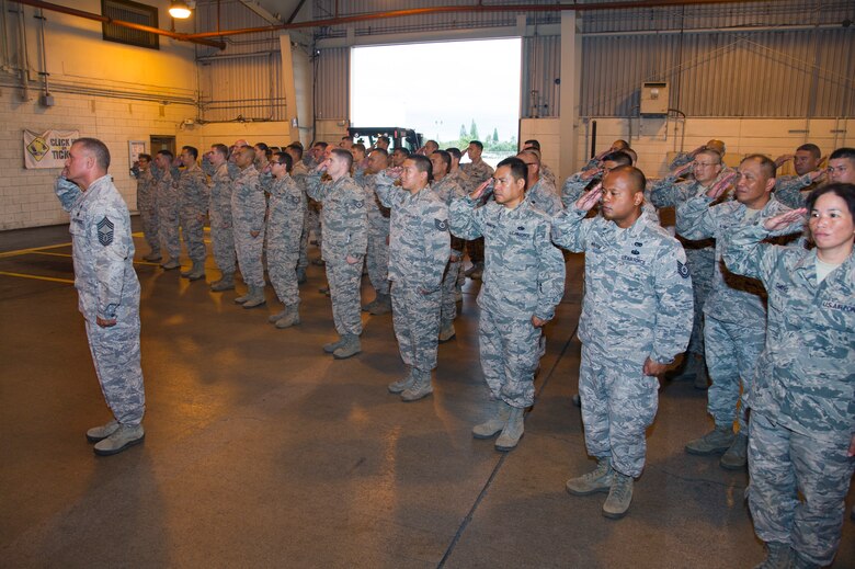 U.S. Air Force Reserve members from the 48th Aerial Port Squadron present Maj. Kenneth Ruggles Jr. with his first salute as the 48th APS commander during an assumption of command ceremony at Joint Base Pearl Harbor-Hickam, Hawaii, April 7, 2018.