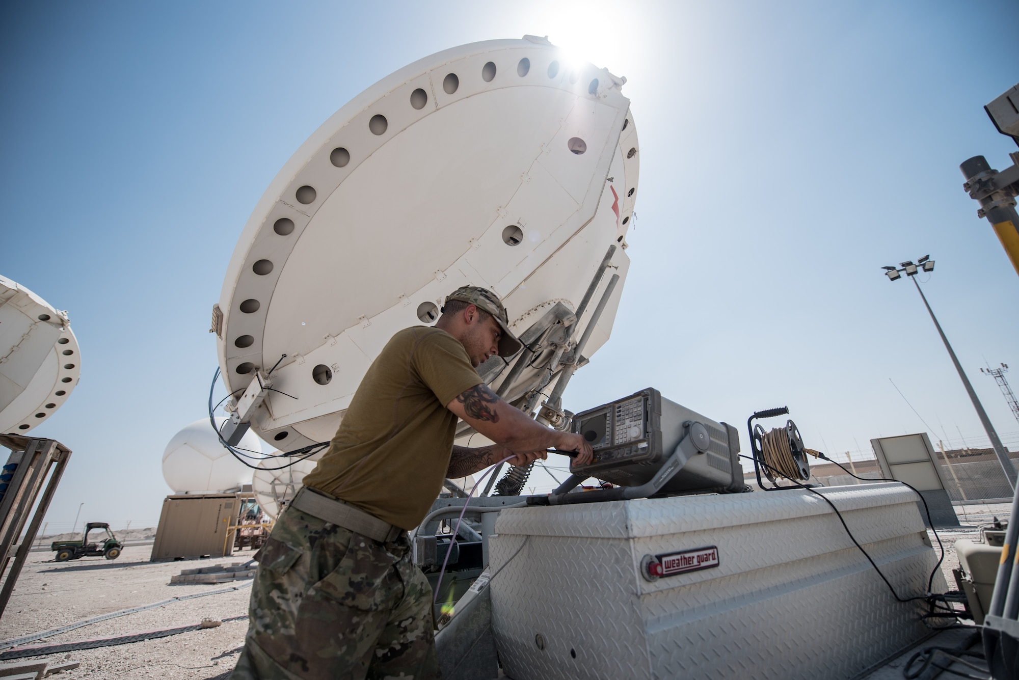 U.S. Air Force Staff Sgt. Joshua Foster, a radio frequency transmissions technician with the 379th Operations Support Squadron, uses a spectrum analyzer to perform diagnostics on a satellite at Al Udeid Air Base, Qatar, Mar. 30, 2018. Silent Sentry protects critical satellite communication links by employing multiple weapons systems for electronic warfare. (U.S. Air National Guard photo by Master Sgt. Phil Speck)