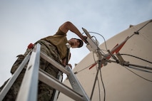 U.S. Air Force Staff Sgt. Joshua Foster, a radio frequency transmissions technician with the 379th Operations Support Squadron, uses a spectrum analyzer to perform diagnostics on a satellite at Al Udeid Air Base, Qatar, Mar. 30, 2018. Silent Sentry protects critical satellite communication links by employing multiple weapons systems for electronic warfare. (U.S. Air National Guard photo by Master Sgt. Phil Speck)