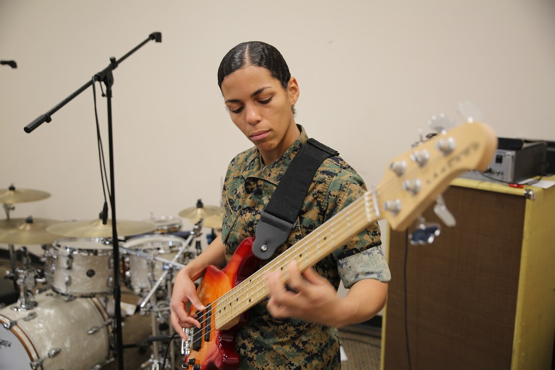Cpl. Deishali DeWitt, a native of Providence, Rhode Island, refines her electric bass skill set aboard Marine Corps Base, Quantico, April 4, 2018. Aside from the bass, Dewitt is also an auxiliary percussionist and works in her training logistical section ensuring the physical fitness standards of the unit stay high. In her spare time, she volunteers at Prince William County Park in Prince William County, Virginia, and the SPCA Animal Shelter in Fredericksburg, Virginia. (U.S. Marine Corps photo by Cpl. Michael McHale)