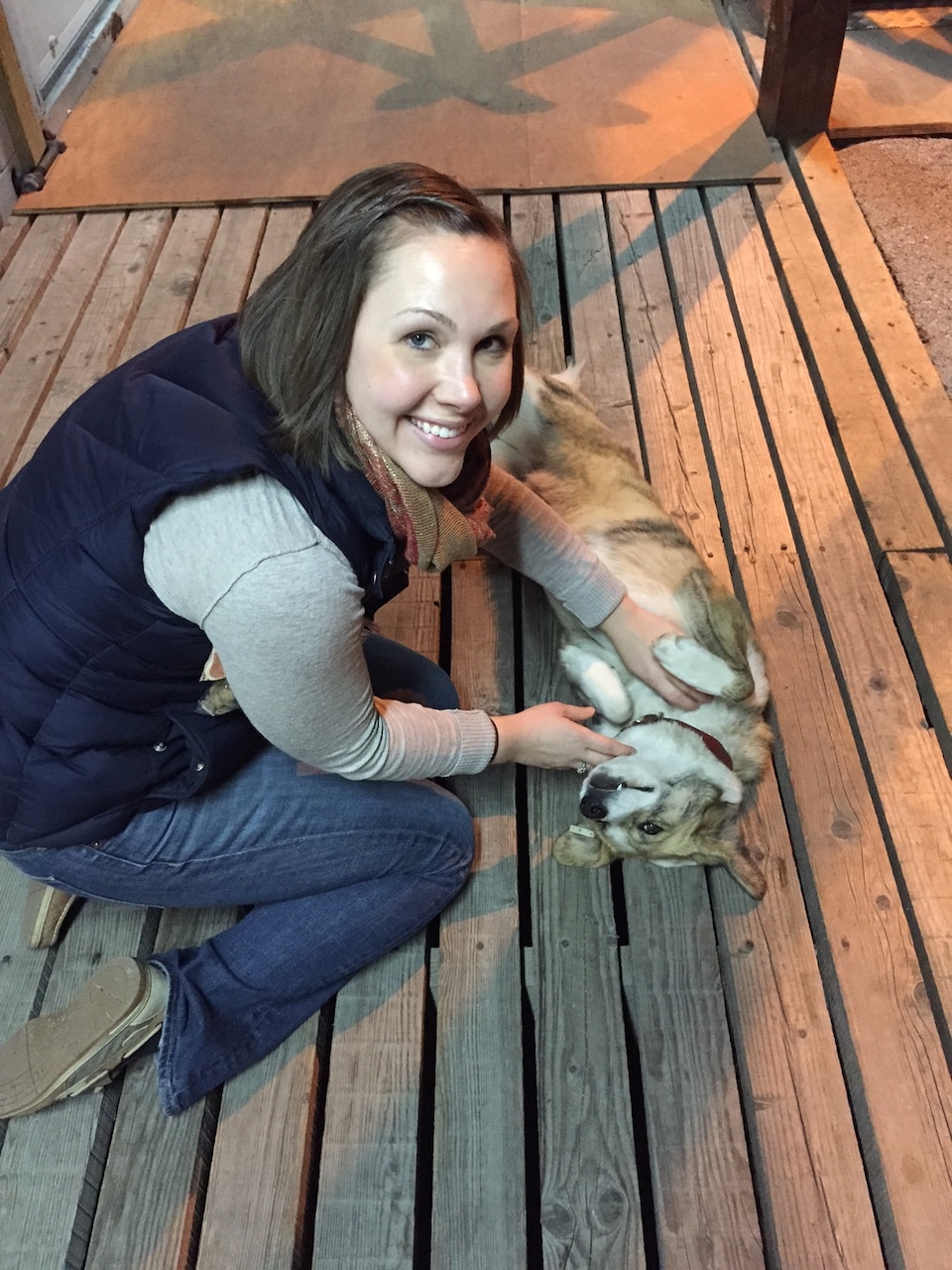 Woman pets a stray dog.