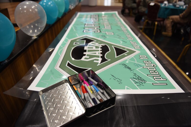 U.S. Air Force Airmen signed a pledge to “never leave a wingman behind” in honor of Sexual Assault Awareness and Prevention Month at Incirlik Air Base, Turkey, April 5, 2018.  The pledge reminded service members to be vigilant, not only during SAAPM month, but year-round. (U.S. Air Force photo by Senior Airman Kristan Campbell)