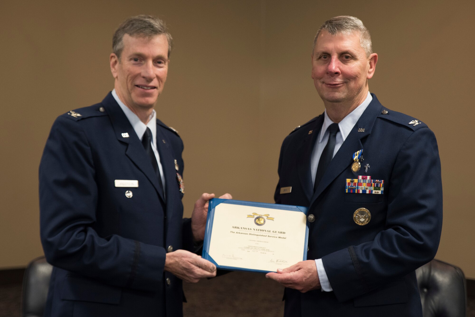Retired Col. Mark W. Anderson, Former Commander 188th Wing, presents Col. Thomas Smith, Joint Force Headquarters Command Chaplain, with the Arkansas Distinguish Service Medal at Fort Smith, AR., Apr. 07, 2018. (U.S. Air National Guard photo by Tech. Sgt. Daniel Condit)