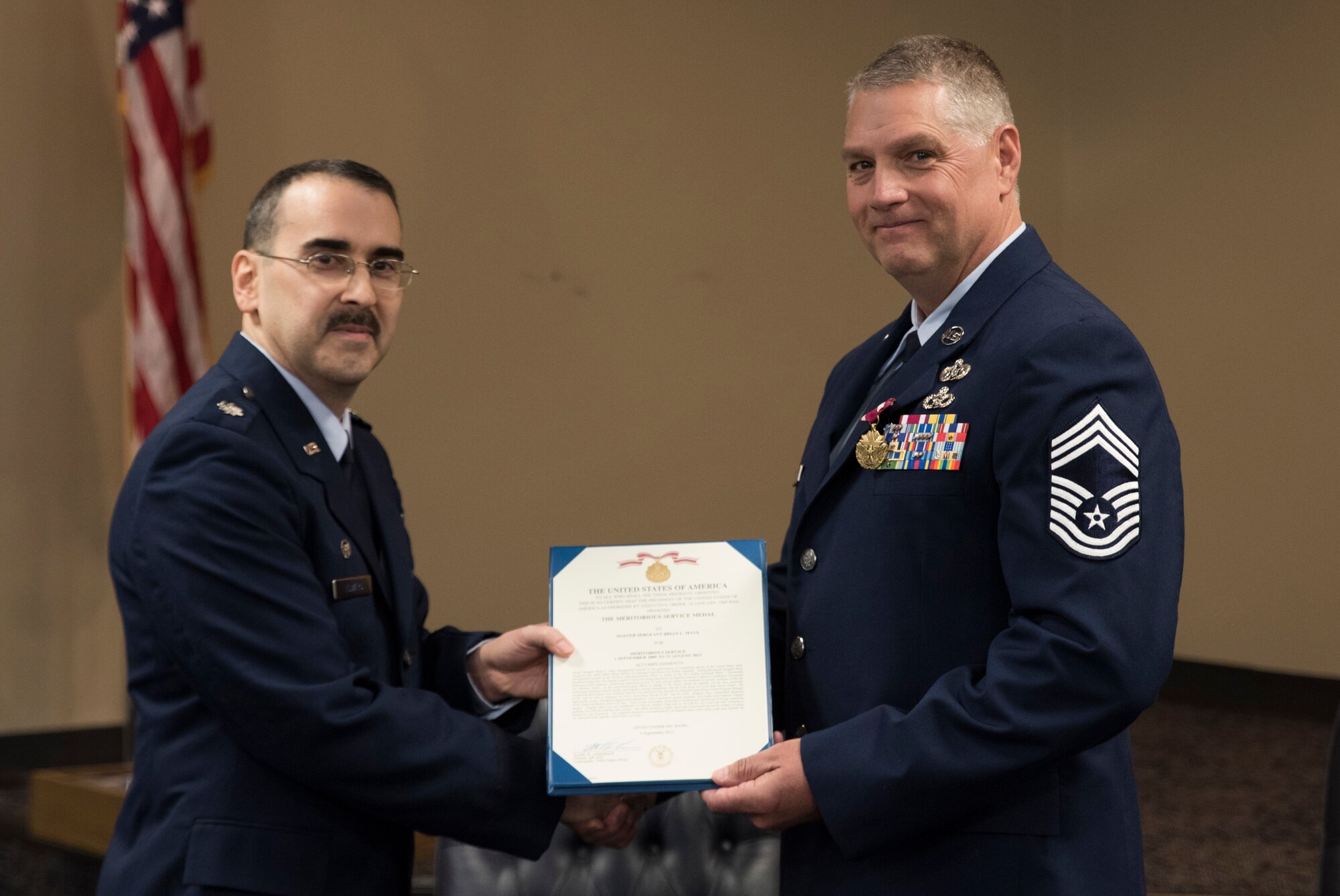 Lt. Col Micheal D. Howard, 188th Civil Engineering Commander, presents Cheif Master Sgt. Ronald W. Redding,188th Civil Engineering Squadron Emergency Management Chief, with the Meritorious Service Medal during Cheif Redding's retirement ceremony at Fort Smith, AR., Apr. 07, 2018. (U.S. Air National Guard photo by Tech. Sgt. Daniel Condit)