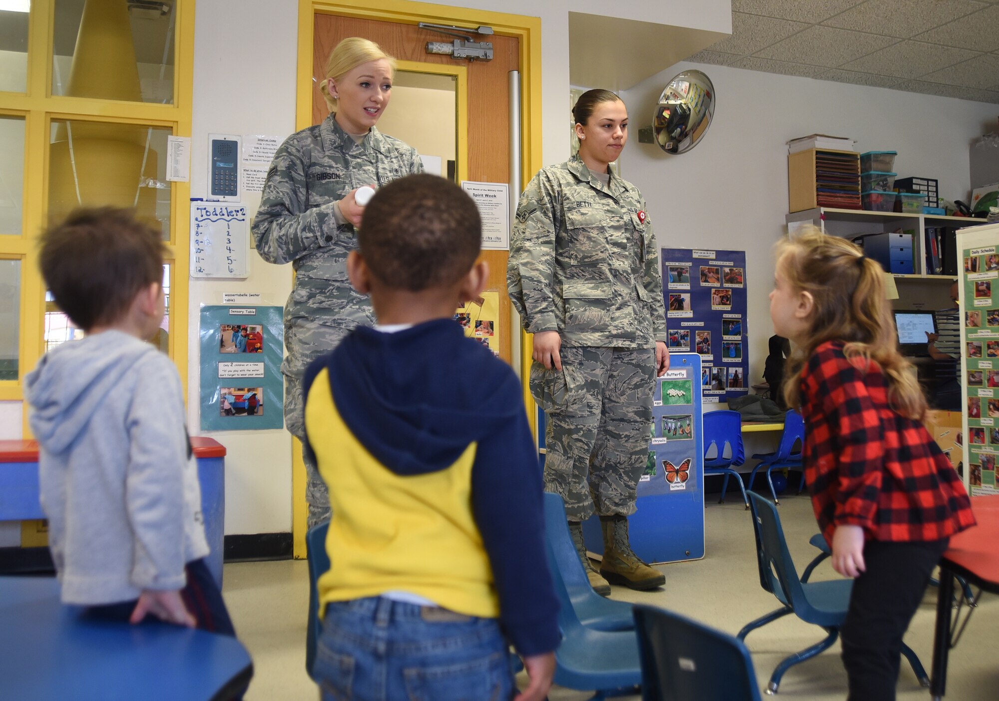 Senior Airman Megan Gibson, left, and Airman Breanna Betti, 22nd Aerospace Medicine Squadron public health technicians, teach toddlers aseptic techniques April 3, 2018, at the Child Development Center in McConnell Air Force Base, Kansas. During National Public Health Week, technicians raised awareness about different health concerns and taught preventative measures.