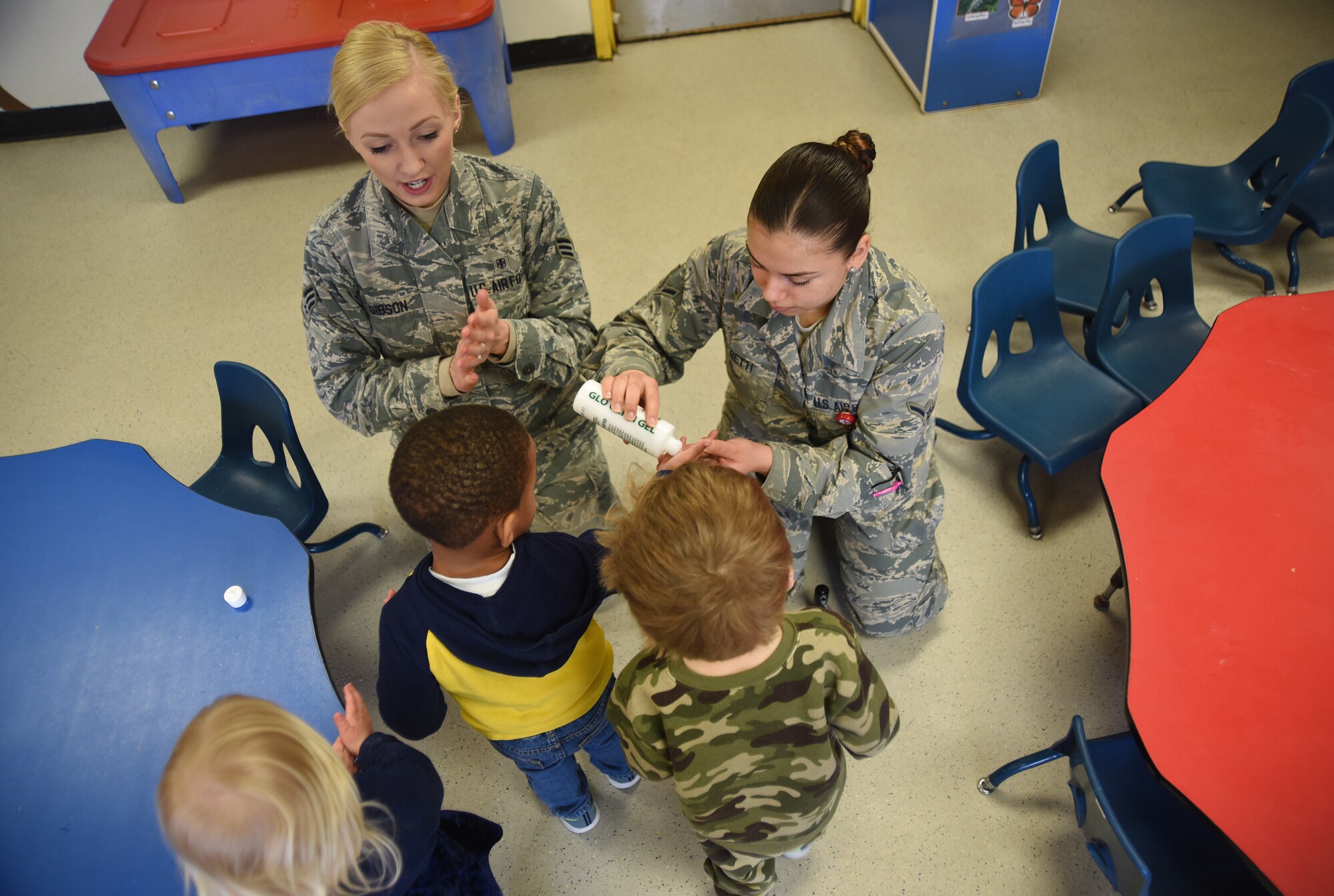 Senior Airman Megan Gibson, left, and Airman Breanna Betti, 22nd Aerospace Medicine Squadron public health technicians, teach toddlers germ-fighting techniques April 3, 2018, at the Child Development Center on McConnell Air Force Base, Kansas. In honor of National Public Health Week, the children learned how to properly wash their hands.