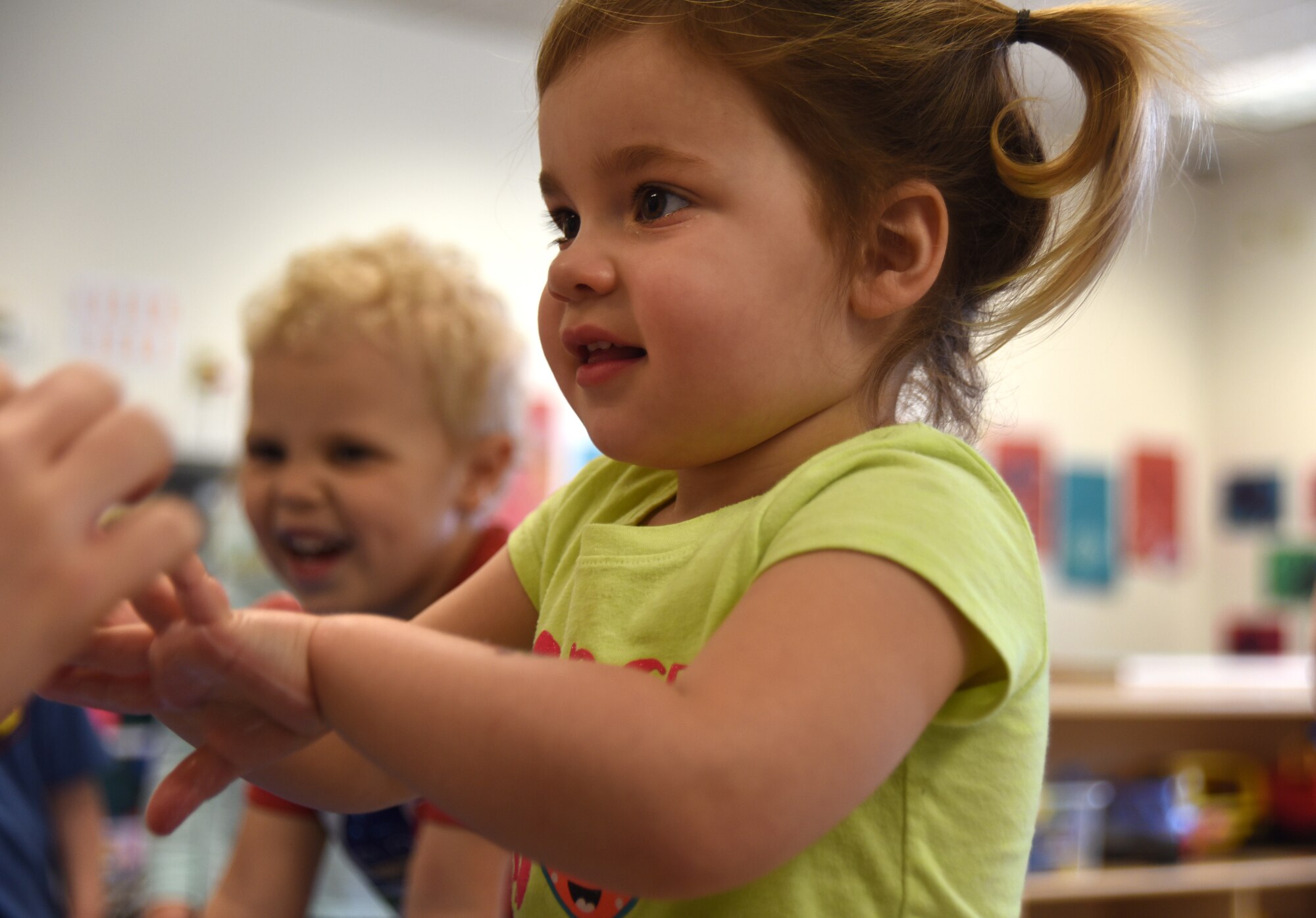 A toddler at the Child Development Center gets a “germ inspection” after washing her hands April 3, 2018, at McConnell Air Force Base, Kansas. In honor of National Public Health Week, medical technicians instructed children how to properly wash their hands and prevent spreading germs.