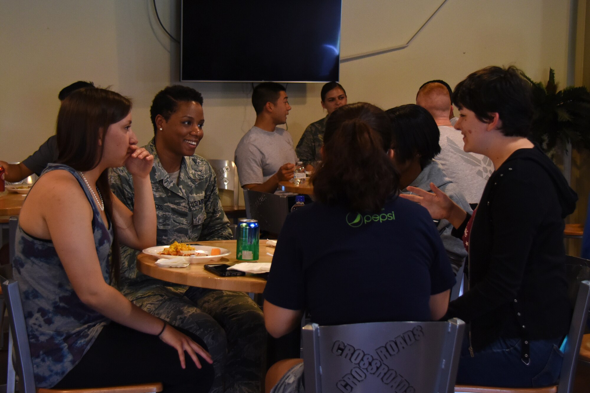 U.S. Air Force Staff Sgt. Sabrina Scruggs, 315th Training Squadron instructor, speaks with trainees during the Top 3 Dorm Dinner at the Crossroads on Goodfellow Air Force Base, Texas, April 5, 2018. Trainees had opportunities to speak with leadership, Top 3 members, as well as other permanent party members about their time in the Air Force. (U.S. Air Force photo by Airman 1st Class Zachary Chapman)
