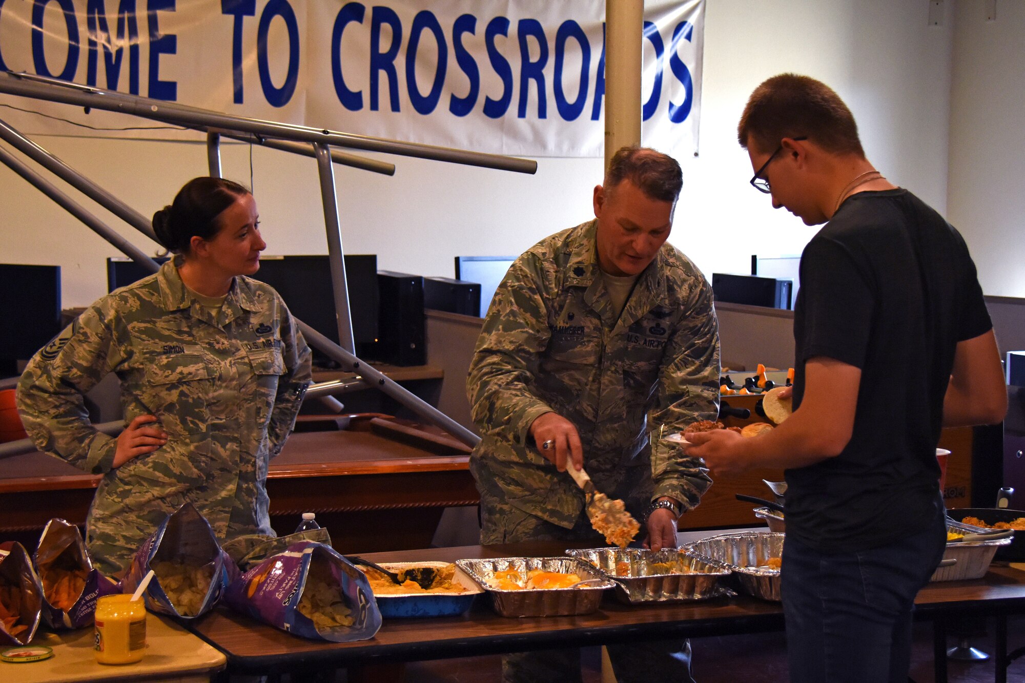 U.S. Air Force Master Sgt. Kristy Simon, 316th Training Squadron assistant first sergeant, and Lt. Col Robert Kammerer, 316th TRS commander, serve food during the Top 3 Dorm Dinner at the Crossroads on Goodfellow Air Force Base, Texas, April 5, 2018. The Top 3 hosts events like this quarterly as part of their base outreach program which provides trainees or permanent party a chance to socialize with the Top 3 and leadership. (U.S. Air Force photo by Airman 1st Class Zachary Chapman)