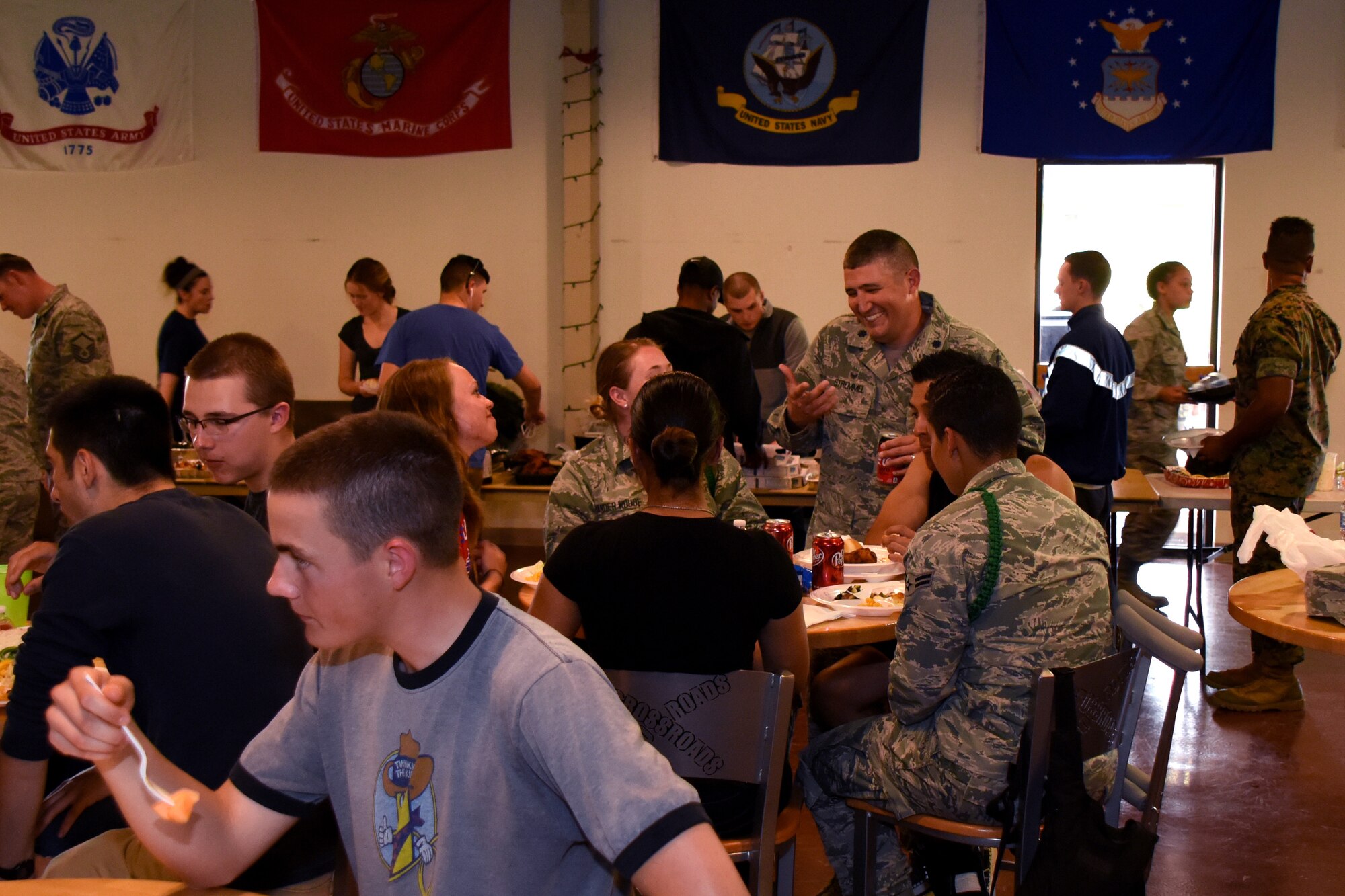 U.S. Air Force Lt. Col. Kenneth Stremmel, 315th Training Squadron commander, talks to trainees during the Top 3 Dorm Dinner at the Crossroads on Goodfellow Air Force Base, Texas, April 5, 2018. Events such as these allow trainees to speak with the commanders and ask question about the Air Force or their personal lives. (U.S. Air Force photo by Airman 1st Class Zachary Chapman)
