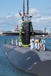 Submarine festooned with a lei of flowers arrives in Hawaii.