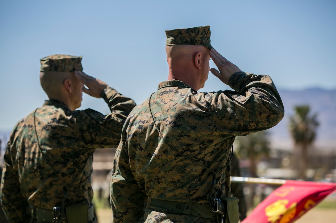 Sgt. Maj. Edward G. Zapata Jr., off-going battalion sergeant major, 7th Marine Regiment, and Sgt. Maj. Anthony J. Pompos, on-coming battalion sergeant major, 7th Marines, render a salute during a pass and review at the conclusion of a post and relief ceremony at Lance Cpl. Torrey L. Grey Field aboard the Marine Corps Air Ground Combat Center, Twentynine Palms, Calif., March 29, 2018. During the ceremony Zapata relinquished his post to Pompos. (U.S. Marine Corps photo by Lance Cpl. Margaret Gale)