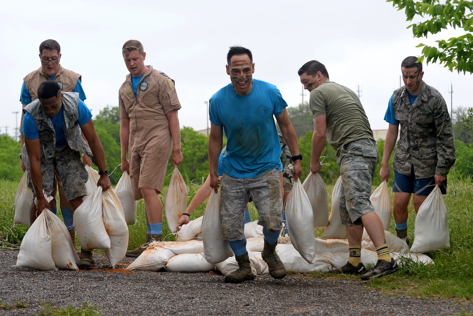 The 91st Cyberspace Operations Squadron “Demon Chasers” team builds a sandbag wall during the 67th Cyberspace Wing annual safety day “Gunslinger” warrior challenge at Joint Base San Antonio-Lackland, Texas, April 6, 2018. The challenge pitted several teams against one another in seven timed events, where the 68th Network Warfare Squadron “Purple Dragons” captured first place. (U.S. Air Force photo by Tech. Sgt. R.J. Biermann)