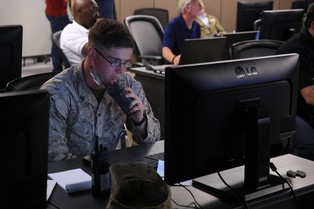 Cpl. Ryan Griffing, rifleman, 1st Battalion, 4th Marine Regiment, stationed out of Marine Corps Base Camp Pendleton, Calif., calls in a 9-line during Command Post Exercise 2 at the Battle Simulation Center aboard the Marine Corps Air Ground Combat Center, Twentynine Palms, Calif., March 29, 2018. CPX-2 is a two-part training event that focuses on training battalion staff and is a part of TALONEX 2-18, a pre-deployment training event that coincides with Weapons and Tactics Instructors Course. (U.S. Marine Corps photo by Lance Cpl. Isaac Cantrell)