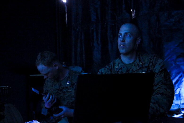 Maj. Jesse Attig (right), modeling and simulations officer, Marine Air Ground Task Force Training Command, evaluates units during Command Post Exercise 2 at the Battle Simulation Center aboard the Marine Corps Air Ground Combat Center, Twentynine Palms, Calif., March 29, 2018. CPX-2 is a two-part training event that focuses on training battalion staff and is a part of TALONEX 2-18, a pre-deployment training event that coincides with Weapons and Tactics Instructors Course. (U.S. Marine Corps photo by Lance Cpl. Isaac Cantrell)