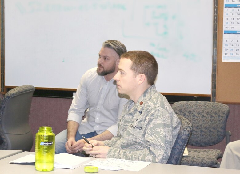 Eddie Mickle, left, work planner for the Aeropropulsion Combined Test Force at Arnold Air Force Base, in a scheduling meeting March 26. Maj. Michael Knauf, AEDC Aeropropulsion Operations Officer, looks on at right. Mickle has been recognized by his supervisors for his efforts supporting the integrated schedule, which serves as a valuable tool to assess progress and issues. (U.S. Air Force photo/Deidre Ortiz)