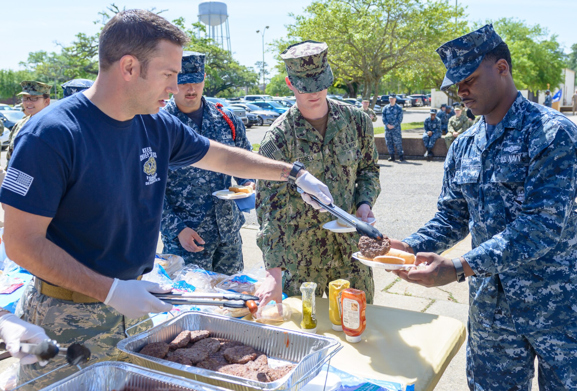 U.S. Air Force Master Sgt. Joshua Anderson, 81st Training Support Squadron military training leader course instructor supervisor, serves food to U.S. Navy Aerographer’s Mate Third Class Jackie Ray, Center for Naval Aviation Technical Training Unit Keesler student, during the CNATTU Keesler’s Chief Petty Officer Birthday Ceremony at Keesler Air Force Base, Mississippi, April 5, 2018. The U.S. Navy’s Chief Petty Officers are celebrating 125 years of heritage and the naval tradition of Unity, Service and Navigation, which is part of their rate emblem, is symbolized by a fouled anchor with the letters “USN” centered on the anchor. (U.S. Air Force photo by André Askew)