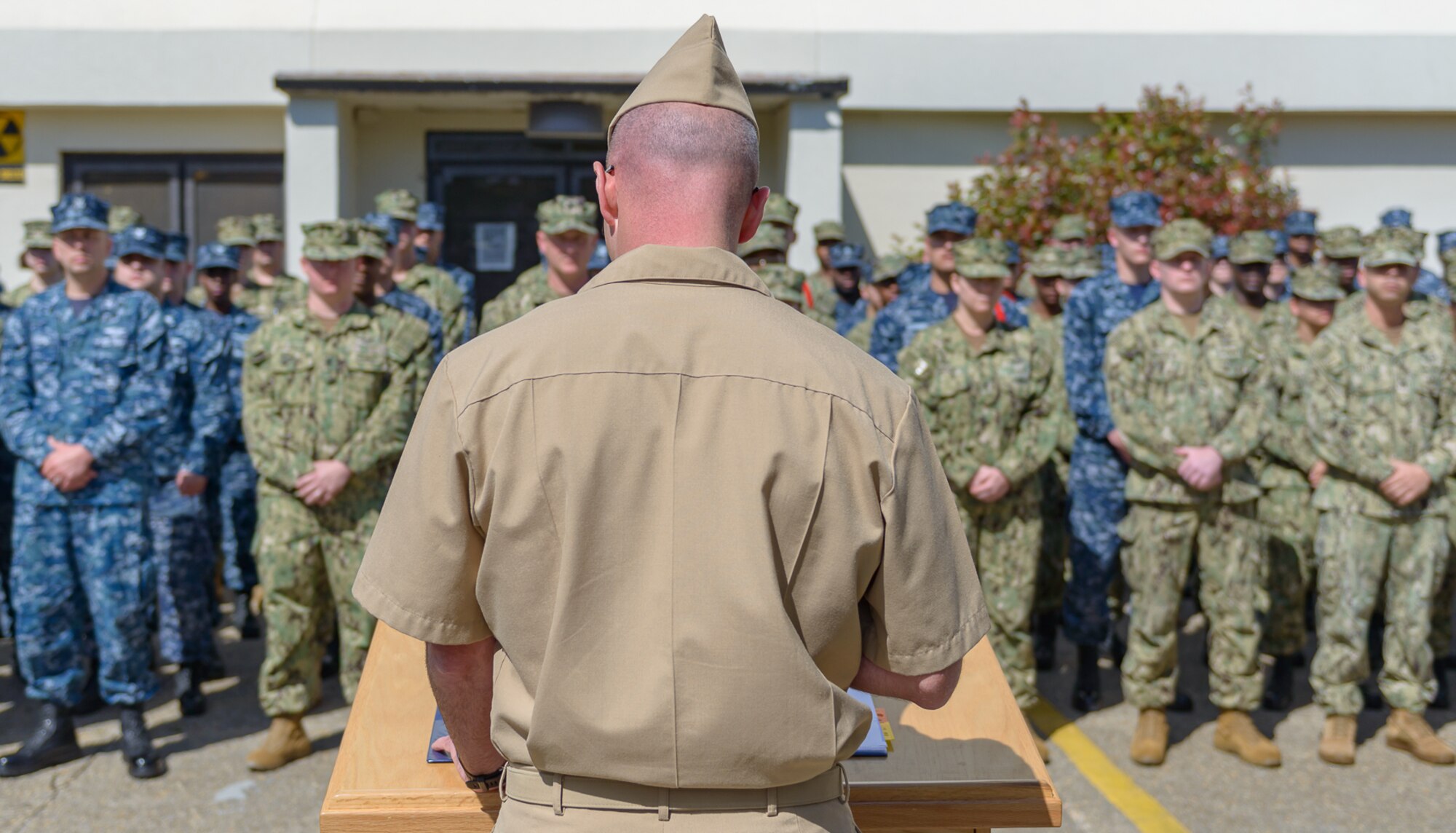 U.S. Navy Cmdr. Timothy Knapp, Center for Naval Aviation Technical Training Unit Keesler commanding officer, delivers opening remarks during the CNATTU Keesler’s Chief Petty Officer Birthday Ceremony at Keesler Air Force Base, Mississippi, April 5, 2018. The U.S. Navy’s Chief Petty Officers are celebrating 125 years of heritage and the naval tradition of 
Unity, Service and Navigation, which is part of their rate emblem, is symbolized by a fouled anchor with the letters “USN” centered on the anchor. (U.S. Air Force photo by André Askew)