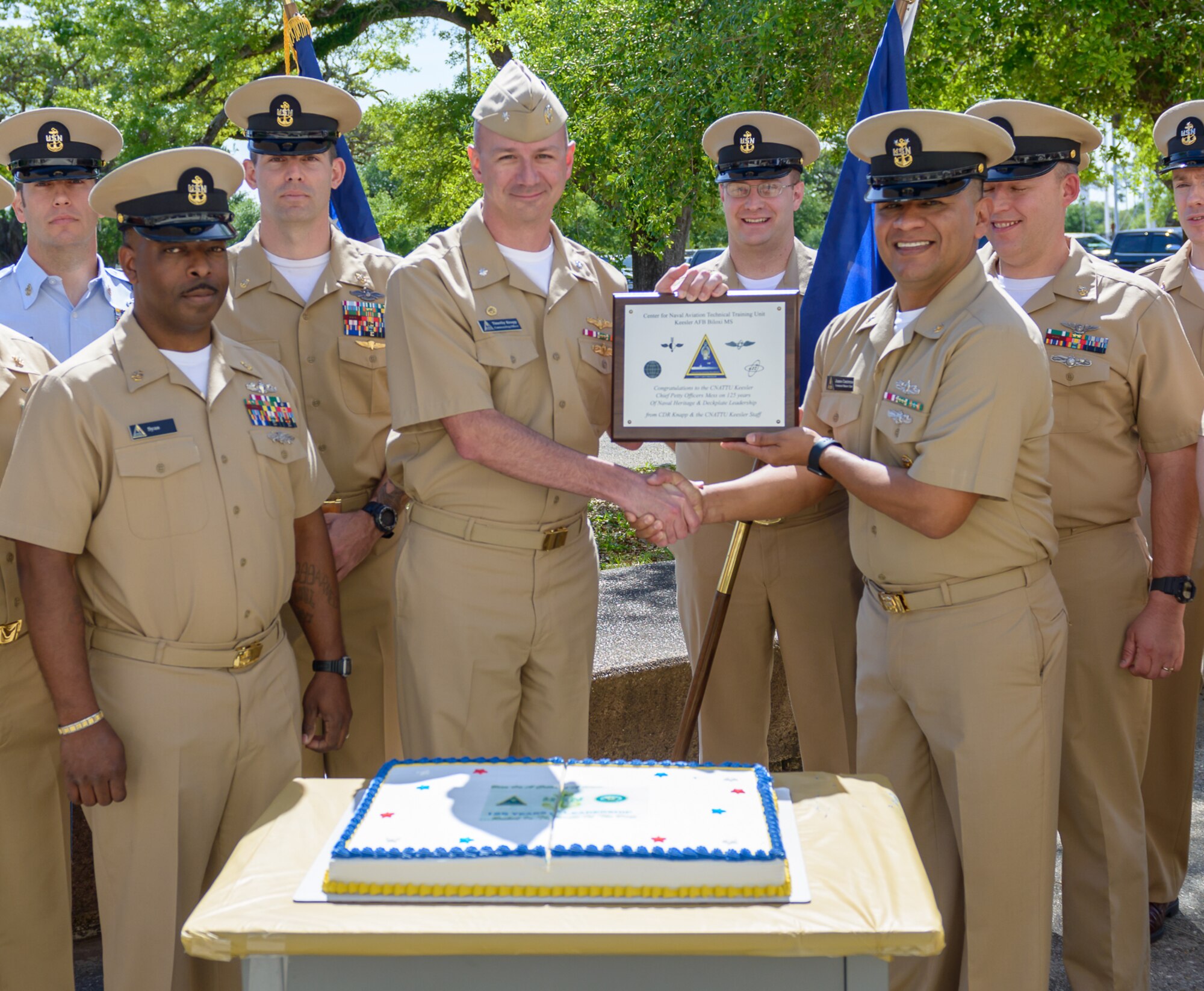 U.S. Navy Cmdr. Timothy Knapp, Center for Naval Aviation Technical Training Unit Keesler commanding officer, presents the Chief’s Mess with a plaque during the CNATTU Keesler’s Chief Petty Officer Birthday Ceremony at Keesler Air Force Base, Mississippi, April 5, 2018. The U.S. Navy’s Chief Petty Officers are celebrating 125 years of heritage and the naval tradition of Unity, Service and Navigation, which is part of their rate emblem, is symbolized by a fouled anchor with the letters “USN” centered on the anchor. (U.S. Air Force photo by André Askew)