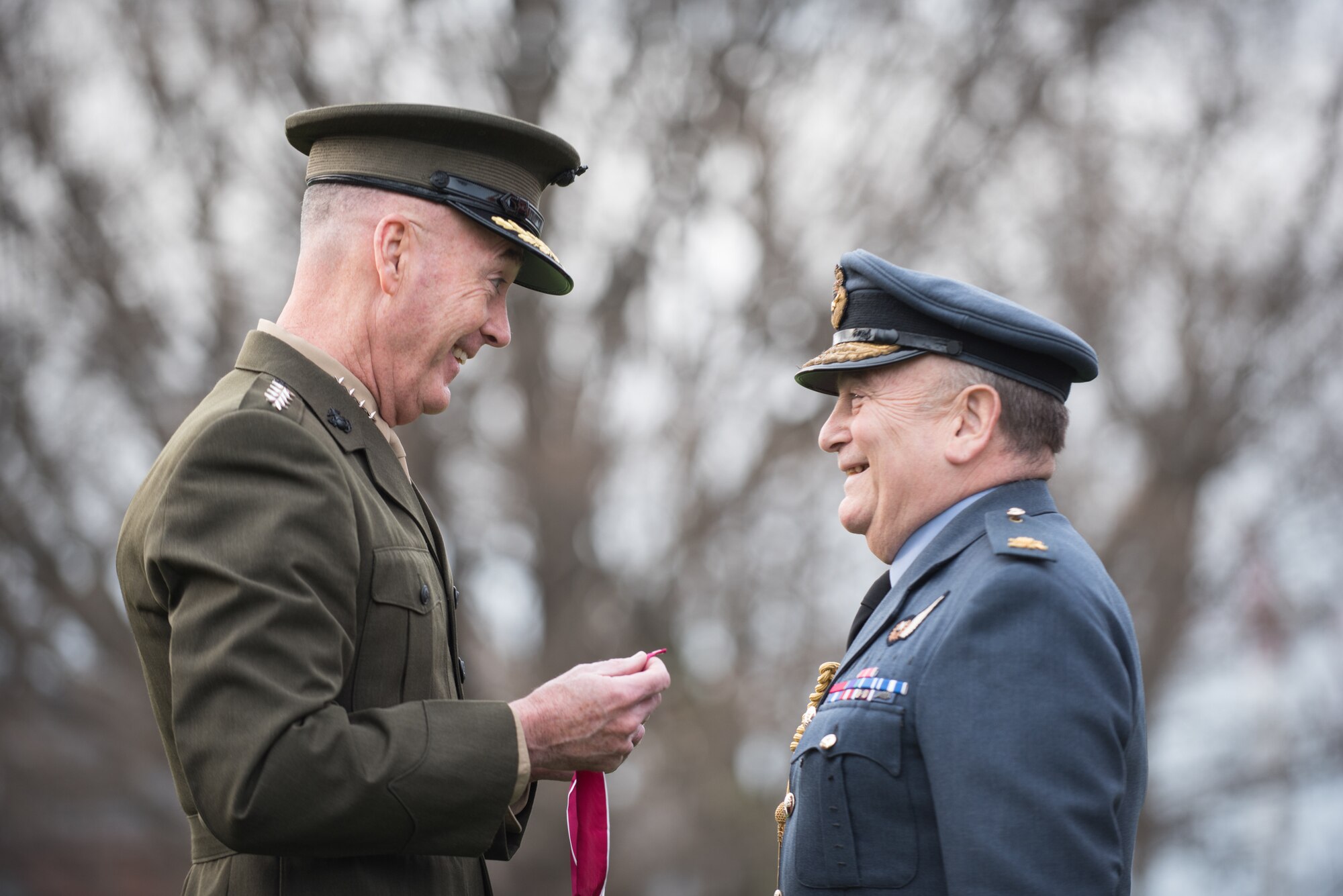 U.S. Marine Corps Gen. Joseph F. Dunford, Jr., chairman of the Joint Chiefs of Staff, prepares to award Air Chief Marshal Sir Stuart Peach, United Kingdom Chief of Defense, the Legion of Merit during an Armed Forces Full Honor Arrival Ceremony at Joint Base Myer-Henderson Hall, April 6, 2018. The award was presented for his efforts to bolster key military support for the Defeat-ISIS Coalition contributing to the significant degradation of ISIS in Iraq and Syria. This is Air Chief Marshal Peach's last visit before he transitions into a new role as the Chairman of the NATO Military Committee. (DoD Photo by U.S. Army Sgt. James K. McCann)