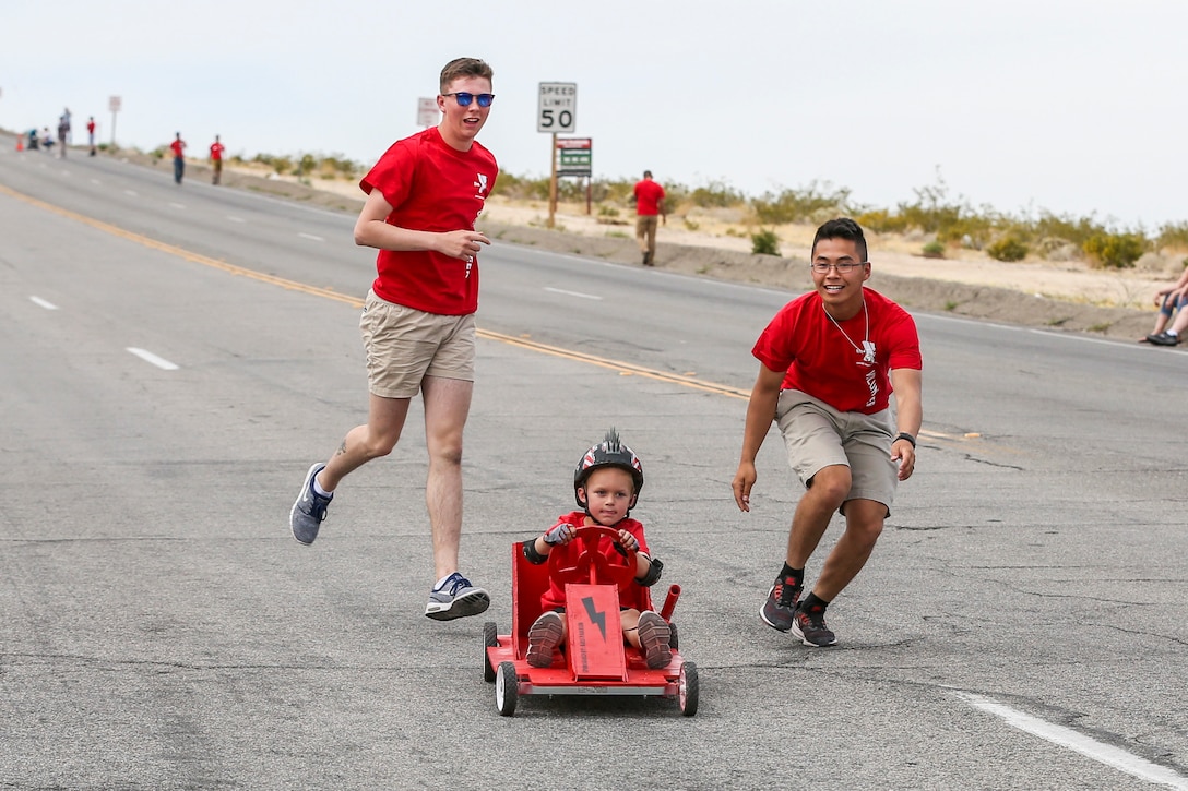 Volunteers with the Armed Services YMCA assist a participant of the soapbox derby down the course during the 18th Annual Car Show and Street Fair, which was hosted by the Twentynine Palms Chamber of Commerce in Twentynine Palms, Calif., March 31, 2018. The annual event is used to bring the community of Twentynine Palms and the Marine Corps Air Ground Combat Center, located in Twentynine Palms, together as well as support local businesses. (U.S. Marine Corps photo by Lance Cpl. Rachel K. Porter)