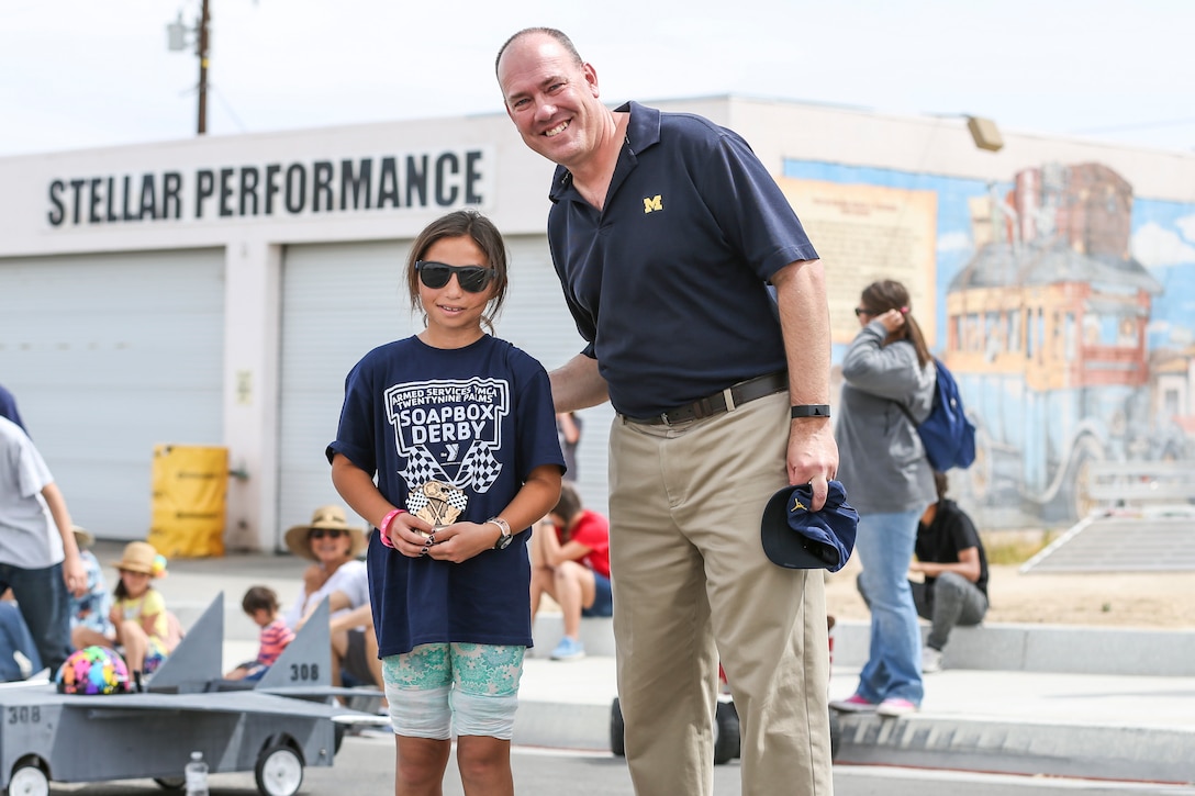 Cmrd. David Stroud, chaplin, Combat Center Protestant Chapel, awards Maribella Grotberg, 10, for winning the General’s Choice Soapbox Derby during the 18th Annual Car Show and Street Fair, which was hosted by the Twentynine Palms Chamber of Commerce in Twentynine Palms, Calif., March 31, 2018. The annual event is used to bring the community of Twentynine Palms and the Marine Corps Air Ground Combat Center, located in Twentynine Palms, together as well as support local businesses. (U.S. Marine Corps photo by Lance Cpl. Rachel K. Porter)