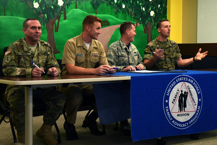 U.S. Army Maj. Ronald Rezac, 344th Military Intelligence Battalion Operations Officer-in-Charge, U.S. Navy Lt. Cmdr. J. Austin Maxwell, Navy Center for Warfare Training Detachment officer in charge, U.S. Air Force Col. Jeffrey Sorrell, 17th Training Wing vice commander, and U.S. Marine Corps Capt. Jason Furman, executive officer for the Marine Corps Detachment on Goodfellow, converse before reading and signing the Child Abuse Prevention Proclamation at the Resiliency Center on Goodfellow Air Force Base, Texas, April 6, 2018. The month of April is dedicated to the awareness and prevention of child abuse throughout the Department of Defense. (U.S. Air Force photo by Airman 1st Class Seraiah Hines/Released)