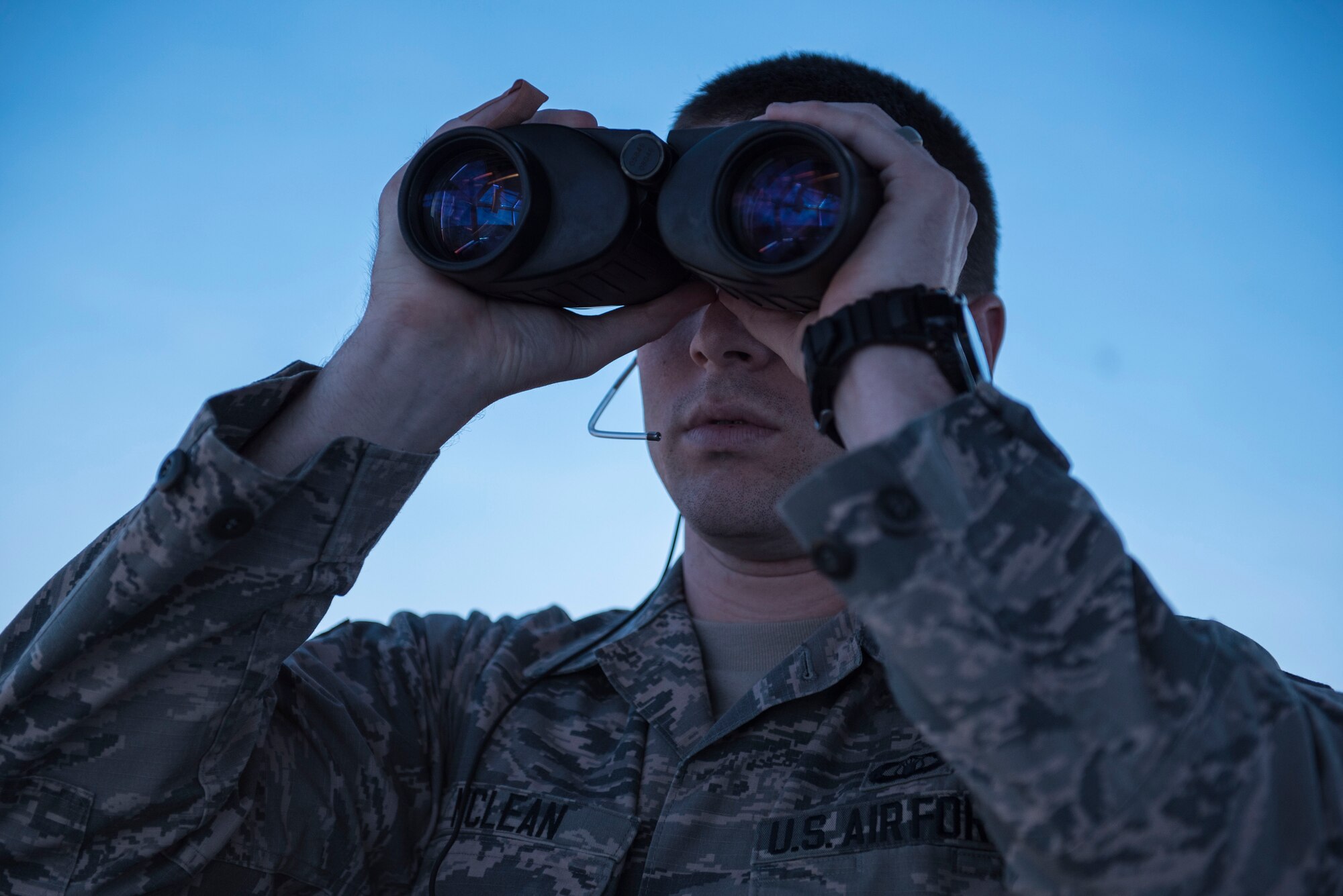 U.S. Air Force Senior Airman Samuel McLean, 20th Operations Support Squadron air traffic controller, looks for aircraft through binoculars at Shaw Air Force Base, S.C., April 5, 2018.