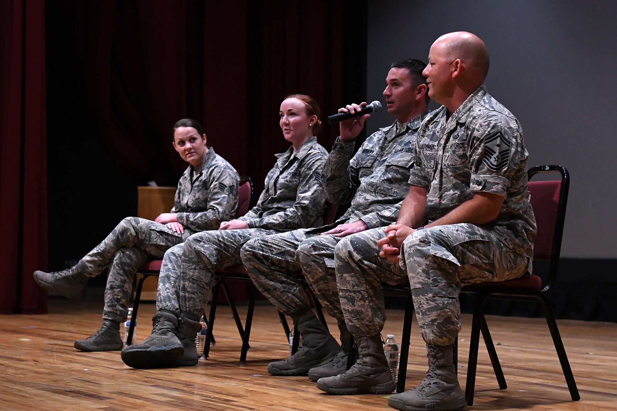 U.S. Air Force Master Sgt. Jason Burdett, 81st Security Forces Squadron first sergeant, answers a question during the question and answer portion of the Airmen Building Airmen Symposium at the Welch Theater at Keesler Air Force Base, Mississippi, April 6, 2018. The symposium also included a guest speaker and a video. The symposium was held to empower Airmen and help them understand the impact they have on the future of the Air Force. (U.S. Air Force photo by Airman 1st Class Suzie Plotnikov)