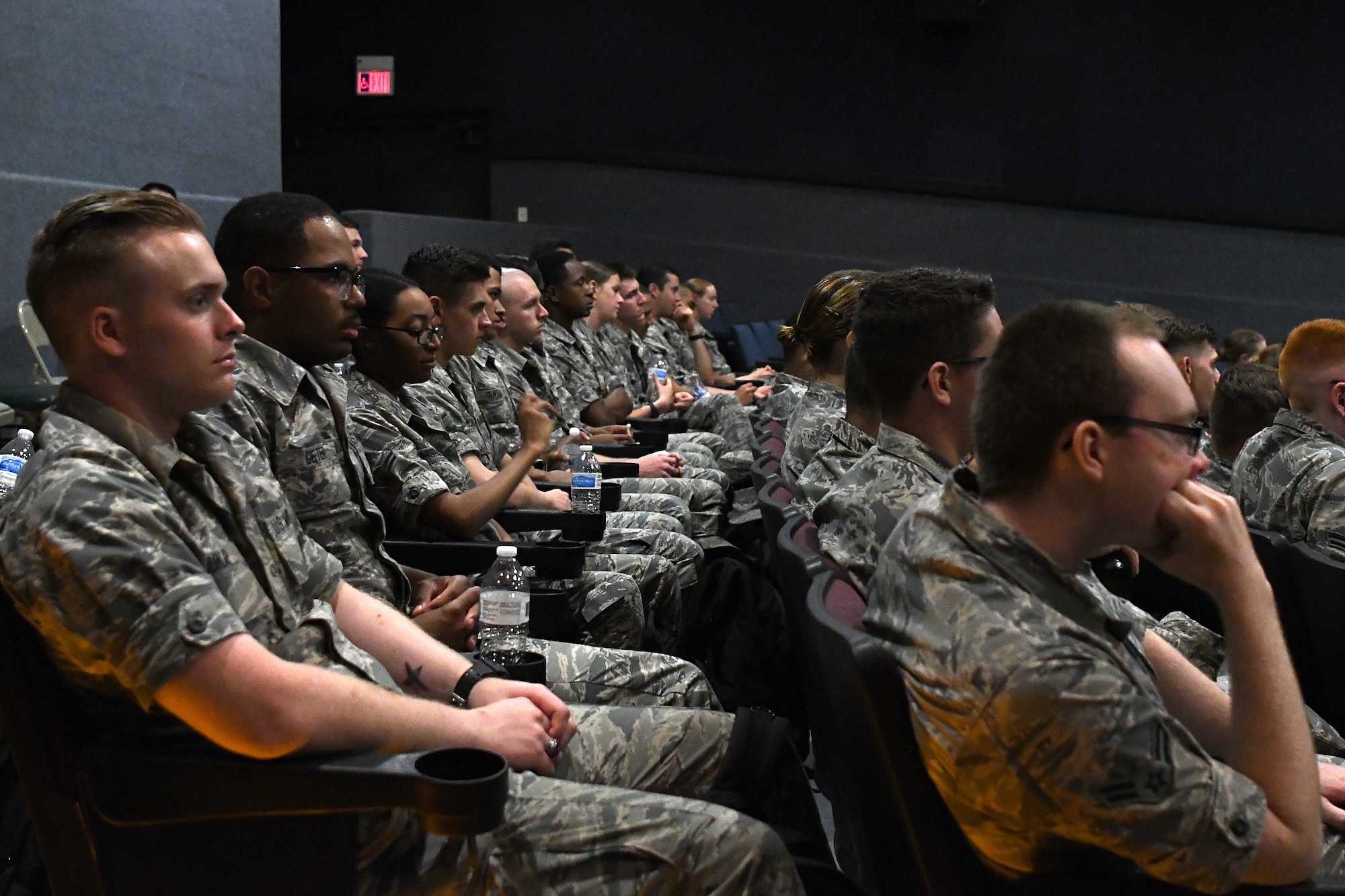 Keesler Airmen attend the Airmen Building Airmen Symposium at the Welch Theater at Keesler Air Force Base, Mississippi, April 6, 2018. The symposium included a guest speaker, a question and answer panel and a video. The symposium was held to empower Airmen and help them understand the impact they have on the future of the Air Force. (U.S. Air Force photo by Airman 1st Class Suzie Plotnikov)