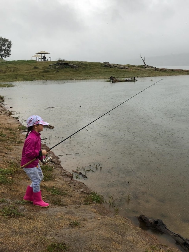A little girl waits for the fish to bite during Kids Fishing Day on April 7, 2018 at Eastman Lake. More than 30 children and their families participated in this years event despite wet, rainy weather.