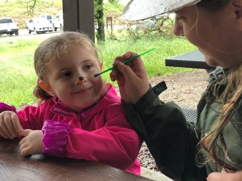 A girl gets her face painted April 7, 2018 during Kids Fishing Day at Eastman Lake. In addition to fishing, there were plenty of activities such as raffles, a casting contest and a DJ playing music for dancing.