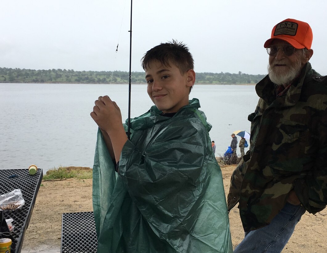 A young boy prepares his fishing rod before casting his line at Kids Fishing Day on April 7, 2018 at Eastman Lake. Experienced anglers were on-hand to teach participants basic fishing skills such as tying hooks, proper casting techniques and patience – an important skill every angler needs.