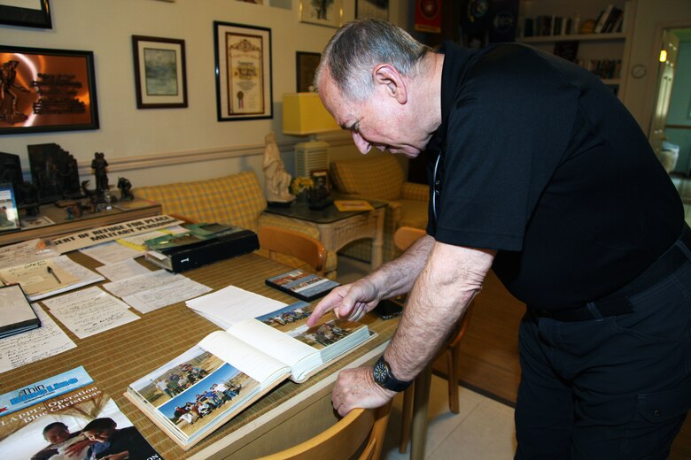 Father Michael McCullough, founder of the Desert Refuge for Peace Officers and Military Personnel, shows photos of events held at the Joshua Tree, Calif., facility during a tour March 7, 2018. McCullough is a Catholic priest and Los Angeles Police Department chaplain. (U.S. Marine Corps photo by Kelly O'Sullivan)