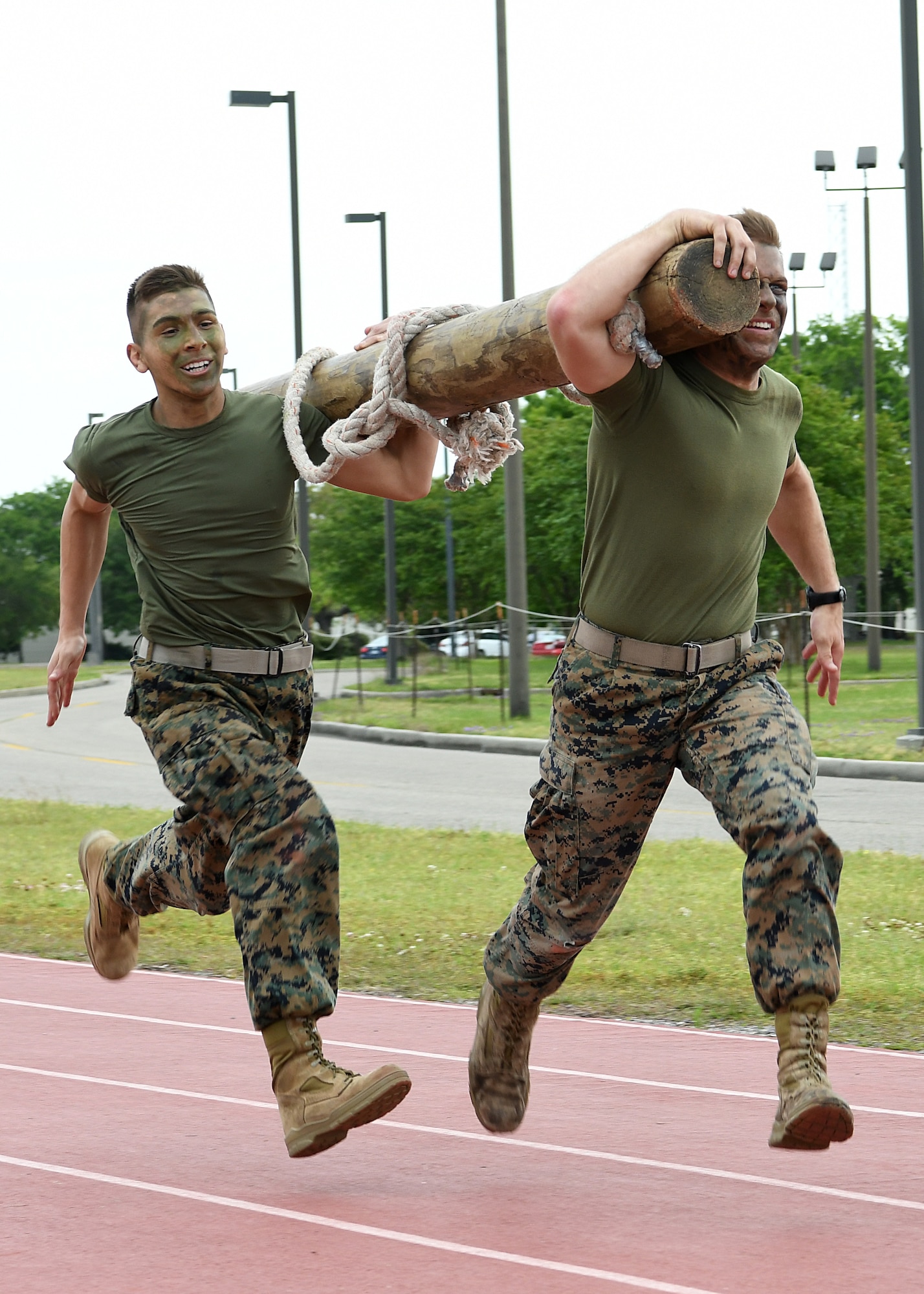 U.S. Marine Corps Private First Class Anthony Maccarelli, Keesler Marine Detachment meteorological oceanographic analyst forecaster student, and Lance Corporal Andrew Parker, Keesler Marine Detachment MOAF student, participate in the log race during the 2nd Annual Warrior Day at the Triangle Track at Keesler Air Force Base, Mississippi, April 6, 2018. The event served to promote unit cohesion, camaraderie and small unit leadership. The winning team received a Warrior Medallion as well as a coin. (U.S. Air Force photo by Airman 1st Class Suzie Plotnikov)
