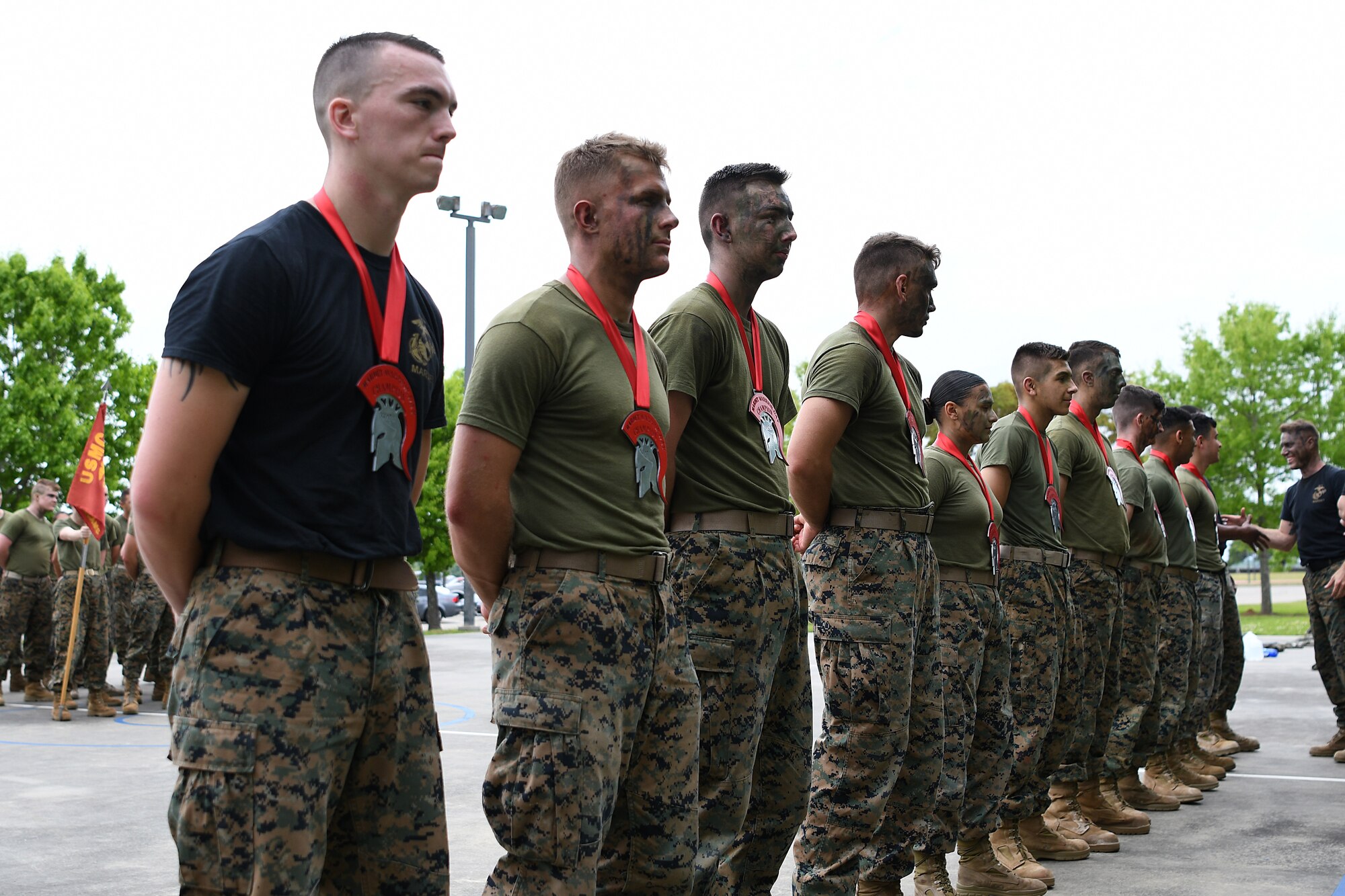 Keesler Marine Detachment students receive their first place warrior medallions during the 2nd Annual Warrior Day at the Keesler Marine Detachment at Keesler Air Force Base, Mississippi, April 6, 2018. Ten teams competed against each other in eight events that served to promote unit cohesion, camaraderie and small unit leadership. The winning team received a Warrior Medallion as well as a coin. (U.S. Air Force photo by Airman 1st Class Suzie Plotnikov)