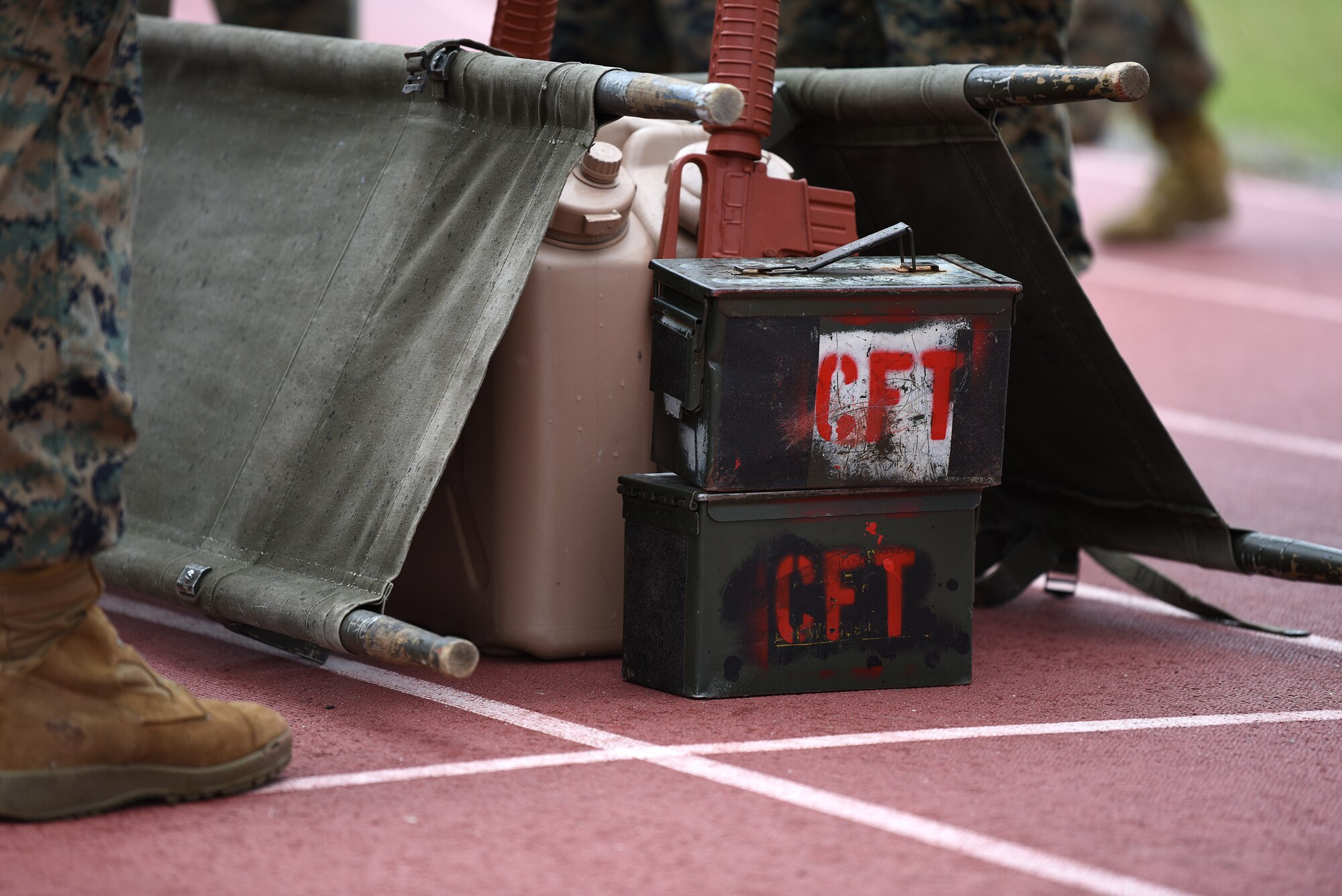 Equipment for the casualty evacuation race is placed on the Triangle Track during the 2nd Annual Warrior Day at Keesler Air Force Base, Mississippi, April 6, 2018. The race included carrying a team member on a stretcher, transporting ammo cans and water jugs. The event served to promote unit cohesion, camaraderie and small unit leadership.  (U.S. Air Force photo by Airman 1st Class Suzie Plotnikov)