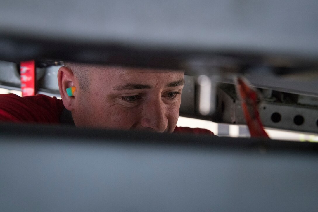 Staff Sgt. Kyle Palmer 75th Aircraft Maintenance Unit weapons load crew member secures an inert munition on an A-10C Thunderbolt II during a weapons load competition, April 6, 2018, at Moody Air Force Base, Ga. The 75th and 74th AMUs went head to head with each crew competing to load three munitions onto the A-10C quicker and with less discrepancies than the other. Crews were also judged on dress and appearance and a written test based on munitions knowledge. (U.S. Air Force photo by Senior Airman Janiqua P. Robinson)