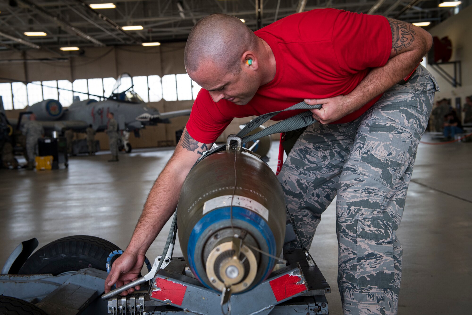 Staff Sgt. Kyle Palmer 75th Aircraft Maintenance Unit weapons load crewmember secures an inert munition on an A-10C Thunderbolt II during a weapons load competition, April 9, 2018, at Moody Air Force Base, Ga. The 75th and 74th AMUs went head to head with each crew competing to load three munitions onto an A-10 quicker and with less discrepancies than the other. Crews were also judged on dress and appearance and a written test based on munitions knowledge. (U.S. Air Force photo by Senior Airman Janiqua P. Robinson)