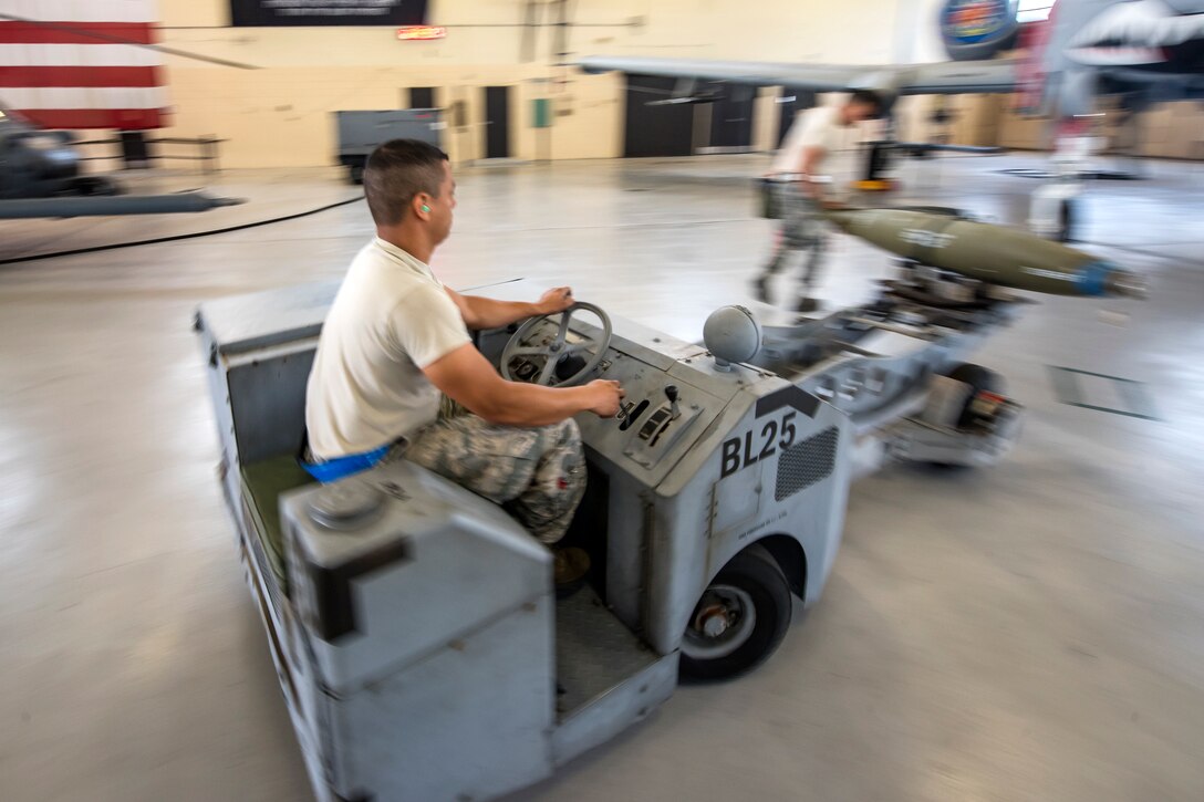 Senior Airman Luis Bautista-Mercedes, 74th Aircraft Maintenance Unit (AMU) weapons load crew member, transports an inert MK-84 general purpose bomb towards an A-10C Thunderbolt II during a weapons-load competition, April 6, 2018, at Moody Air Force Base, Ga. During the load portion of the competition Airmen from the 74th and 75th AMU were assessed on their ability to quickly and efficiently load munitions onto an A-10. They were also judged on dress and appearance and a written test based on munitions knowledge. (U.S. Air Force photo by Airman Eugene Oliver)