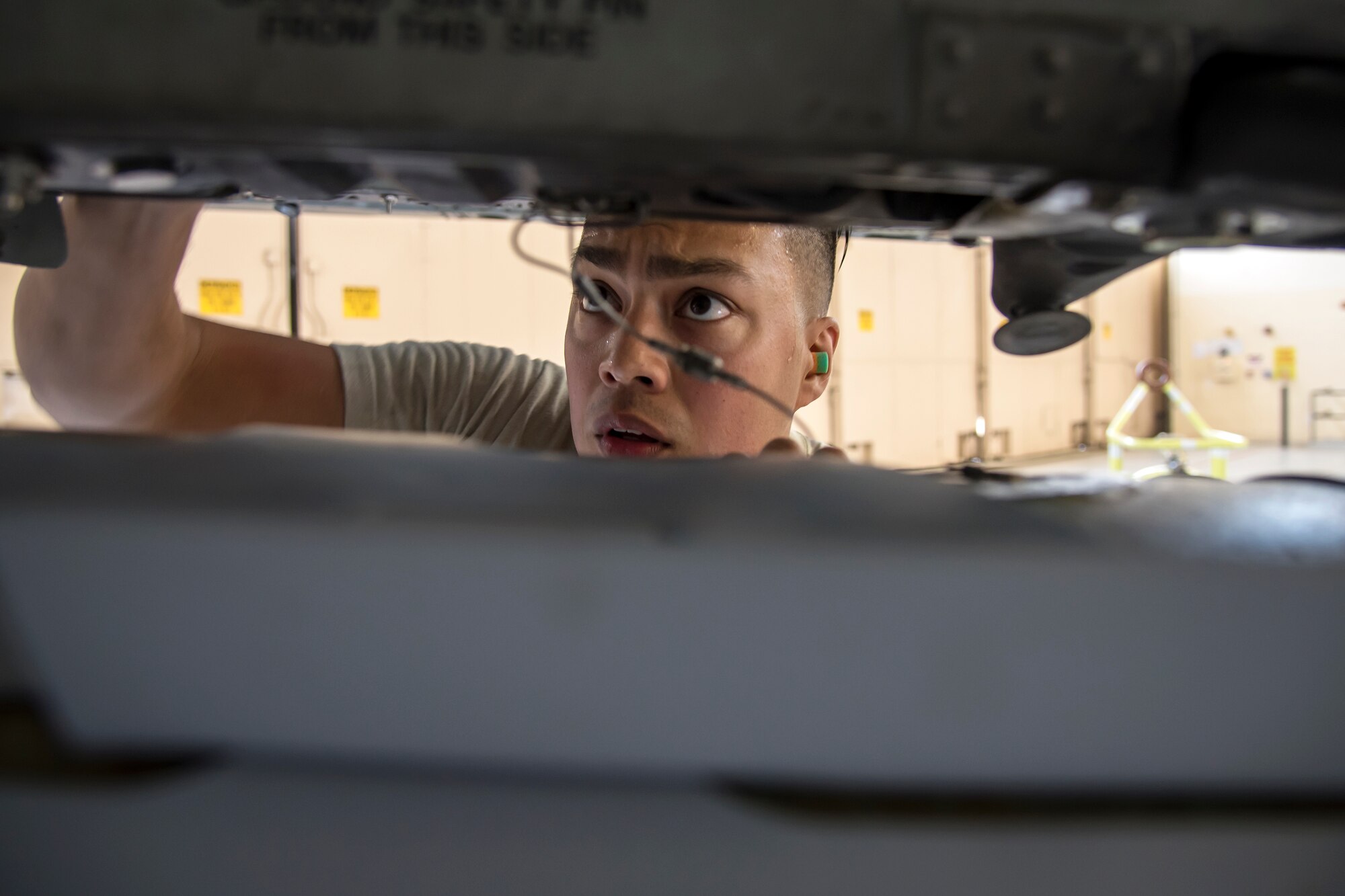 Staff Sgt. Jorge Galvez, 74th Aircraft Maintenance Unit (AMU) weapons load crew team chief, inspects the alignment of an inert MK-84 general purpose bomb during a weapons-load competition, April 6, 2018, at Moody Air Force Base, Ga. During the load portion of the competition Airmen from the 74th and 75th AMU were assessed on their ability to quickly and efficiently load munitions onto an A-10. They were also judged on dress and appearance and a written test based on munitions knowledge. (U.S. Air Force photo by Airman Eugene Oliver)