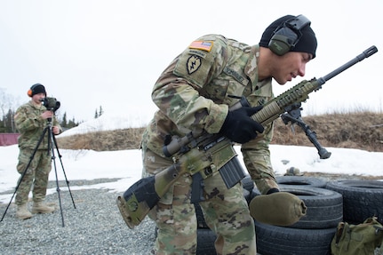 Army Spc. Arturo Dominguez, a native of Okeechobee, Fla., assigned to Charlie Troop, 1st Squadron, 40th Cavalry Regiment (Airborne), 4th Infantry Brigade Combat Team (Airborne), 25th Infantry Division, U.S. Army Alaska, gets in the prone position to fire a M110 Semi-Automatic Sniper System on Statler range at Joint Base Elmendorf-Richardson, Alaska, April 6, 2018, during marksmanship training.  A sniper's main responsibility is to deliver discriminatory, highly accurate rifle fire against enemy targets that cannot be engaged successfully by the regular rifleman due to range, size, location, fleeting nature, or visibility.